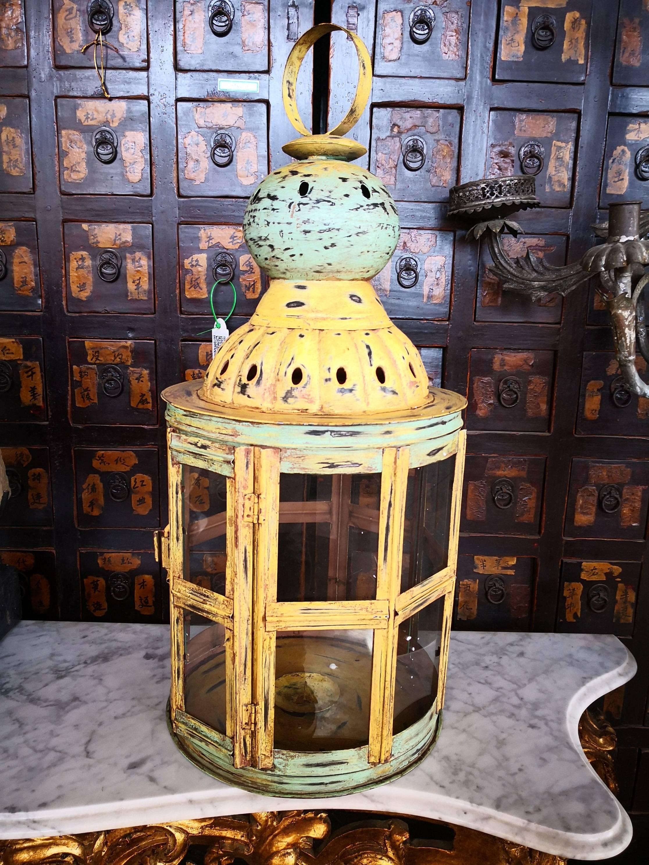 Pair of old style polychrome green and yellow metal lanterns with crystals.