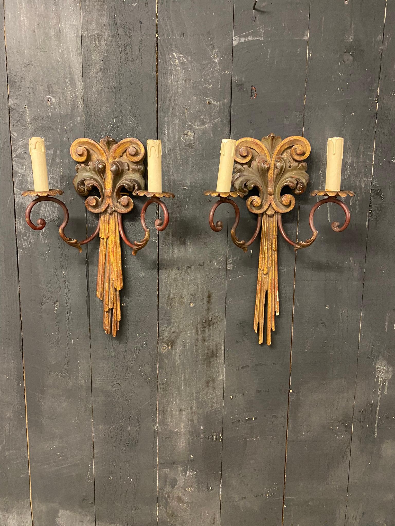 Pair of old wall lights in polychrome wood and wrought iron.
