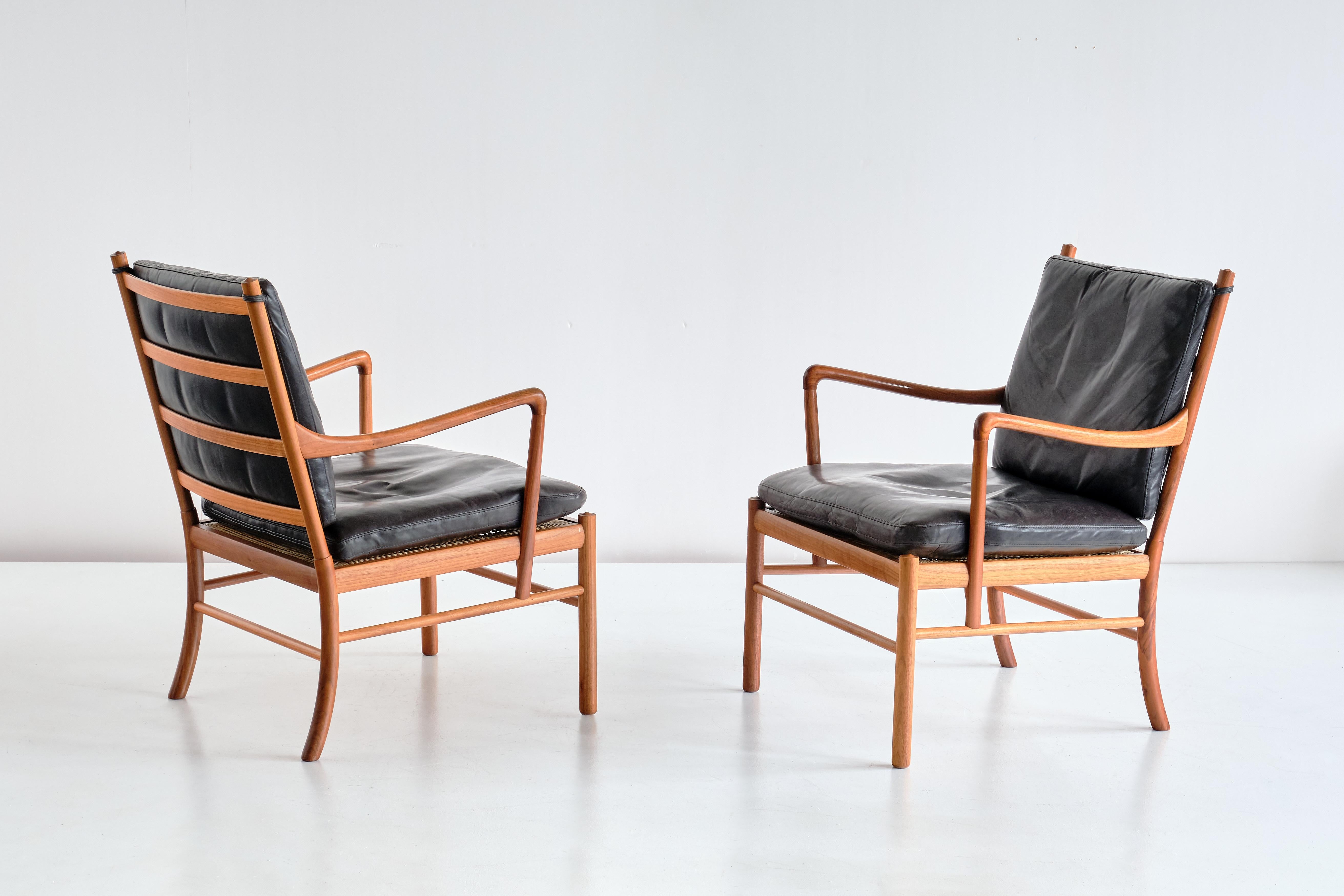 This elegant pair of armchairs was designed by Ole Wanscher and produced by Poul Jeppesen Møbelfabrik in Denmark in the 1950s. This model was numbered 149 and is also known as the 'Colonial Chair'. 
Solid walnut wood frame with the horizontal