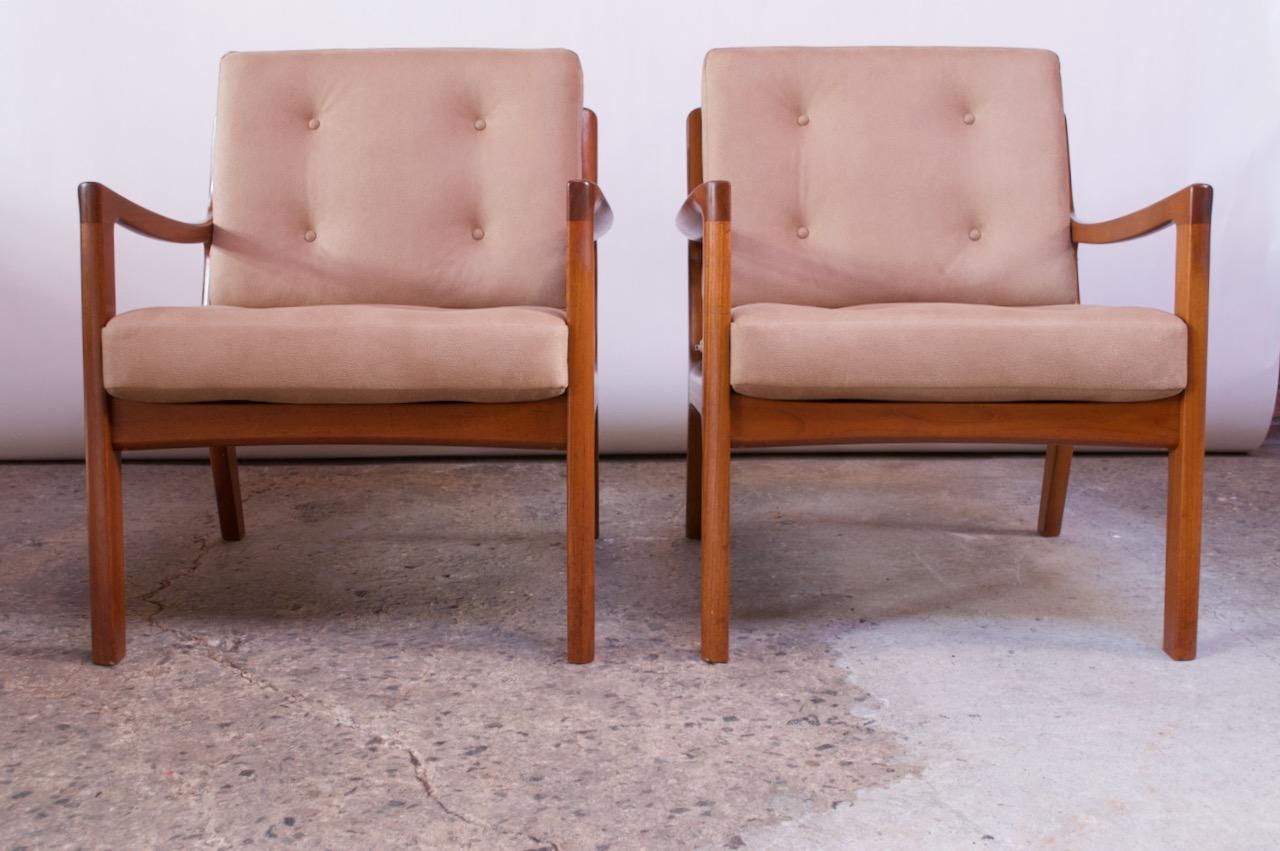 Pair of Danish modern easy chairs (model 116) designed by Ole Wanscher for France & Son.
Composed of a dense slat-back frame, designed with a partially exposed back to better reveal the upholstery. Loose cushions feature a button-tufted pattern on