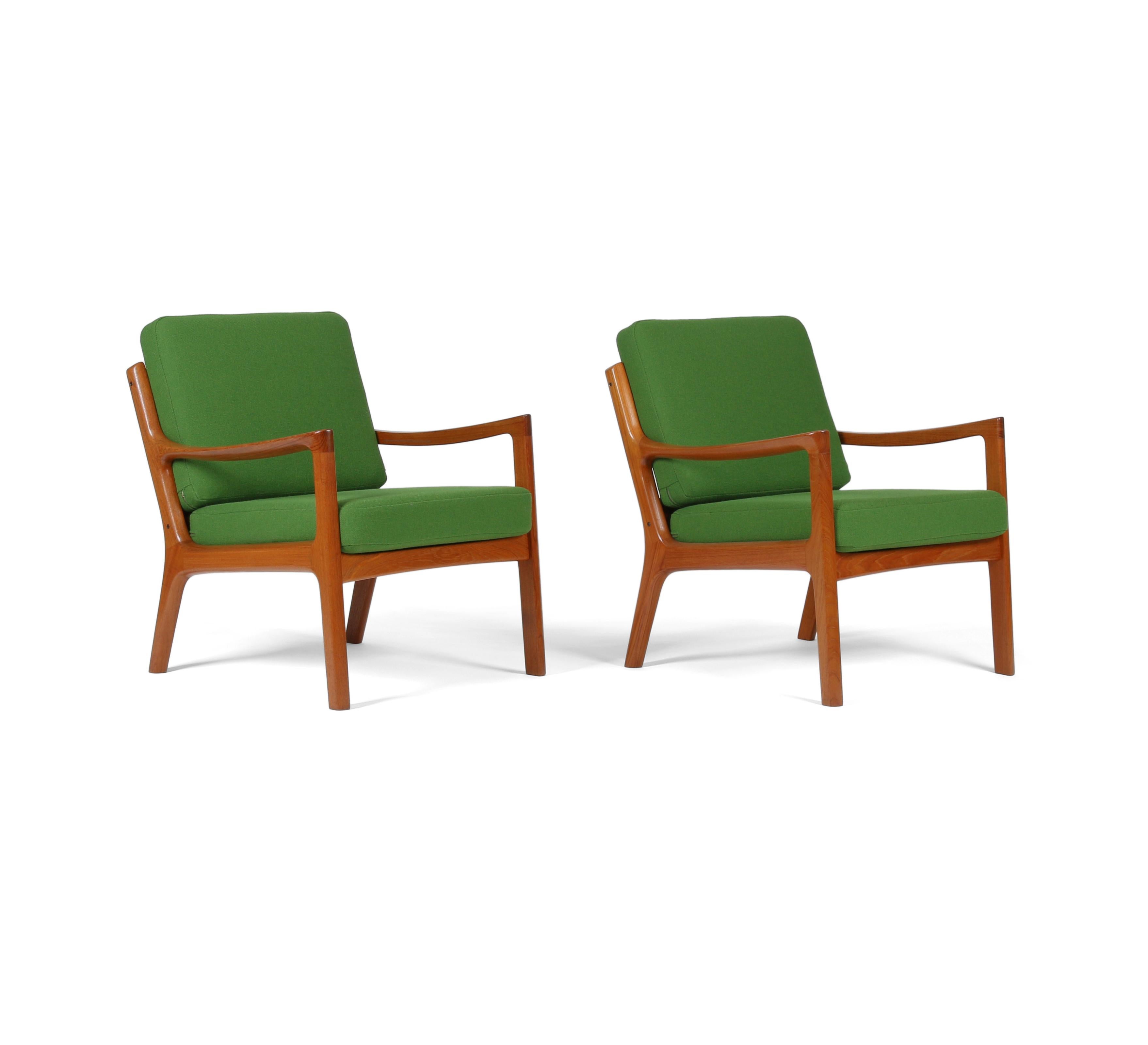 Here is a pair of Danish teak armchairs by Ole Wanscher for France and Søn. This set of “Senator” / No. 166 model lounge chairs was produced in Denmark in the 1960s.

The frames are solid teak with sculptural swooping arms, and have been recently