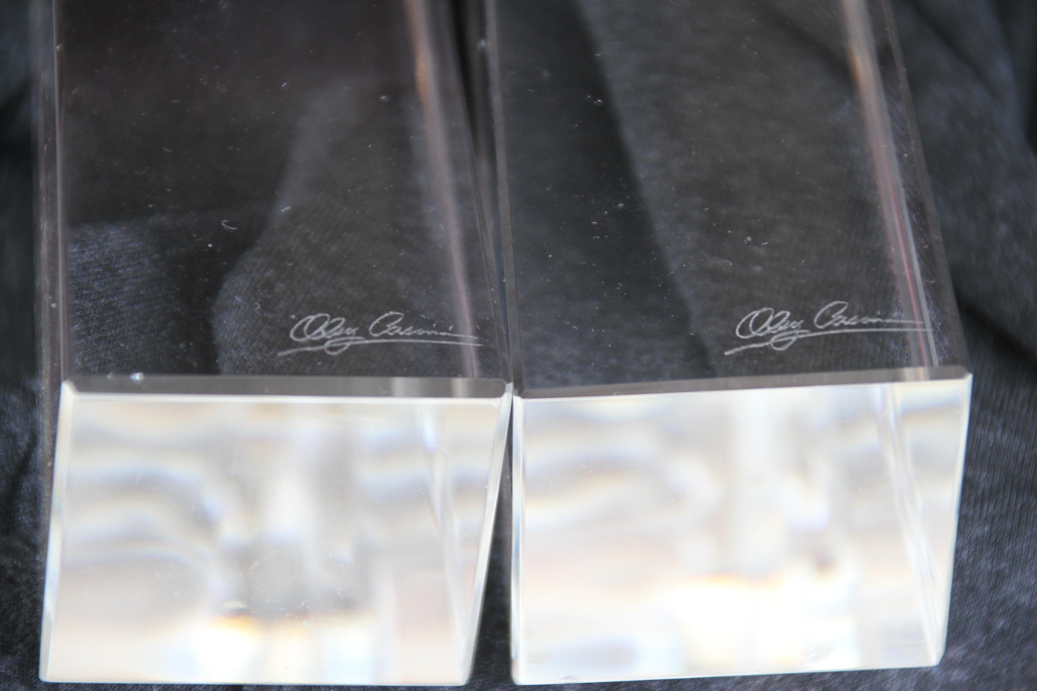 This pair of Oleg Cassini candleholders is constructed of crystal. It's signed by the maker in engraving. They make a nice addition to any room.