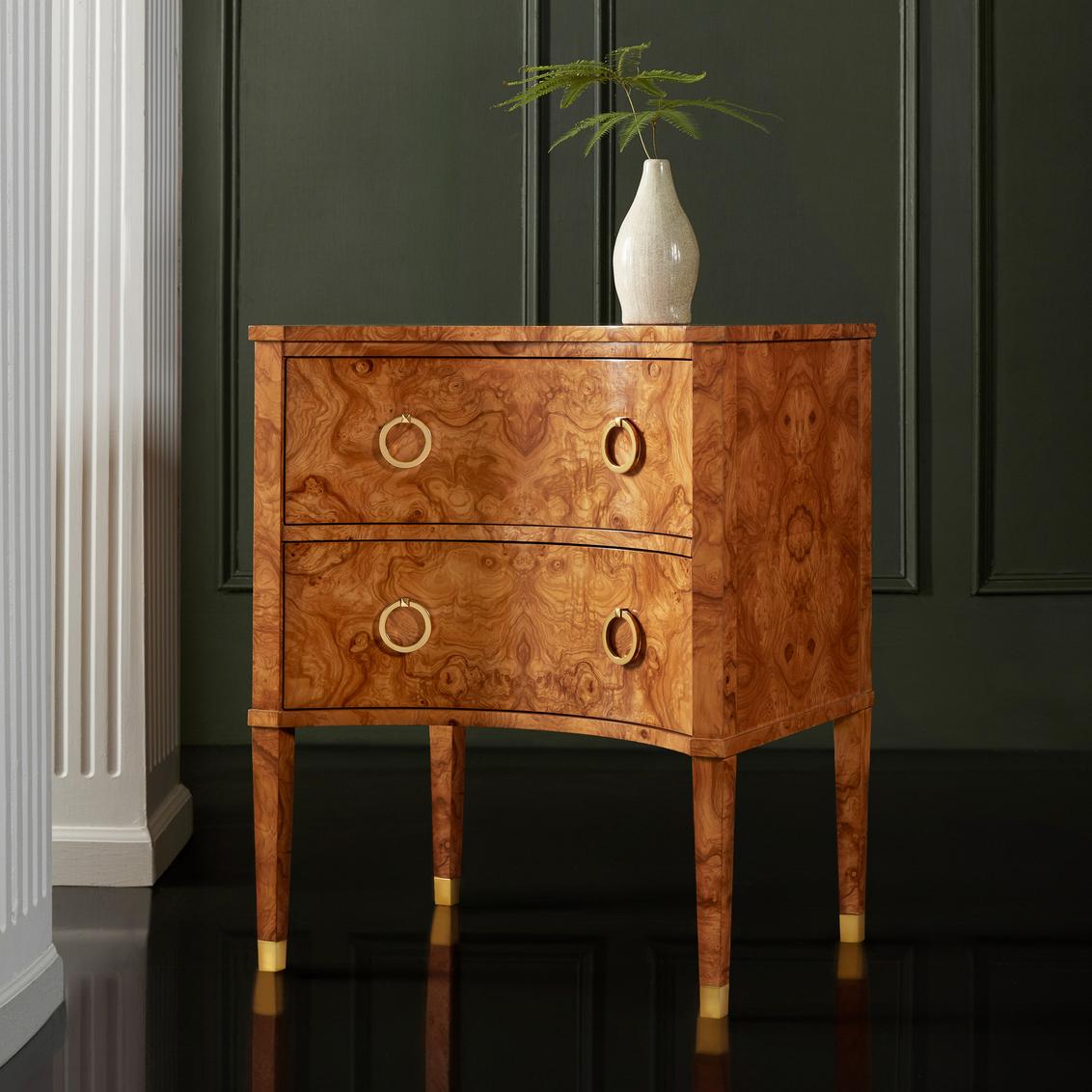 Masterfully crafted in richly figured burl wood, this elegant bedside chest showcases the wood's natural swirling grain patterns through careful veneer selection and matching.  

This versatile two-drawer chest serves beautifully as a bedside table,
