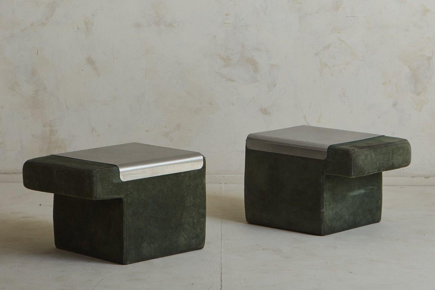 A pair of 1970s French side tables or nightstands clad in original olive green suede with stitch detailing. These tables feature angular profiles and removable aluminum tops, perfect for floating  between living spaces. Unmarked. Sourced in France,