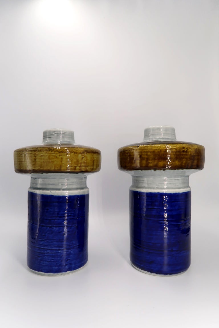 Beautiful color block Scandinavian Mid-Century Modern handmade, hand painted ceramic vases by designer Olle Alberius for Swedish Rörstrand in the 1960s. Cobalt blue base with light grey and bronze glazed top. Light grey glaze on the inside. From the
