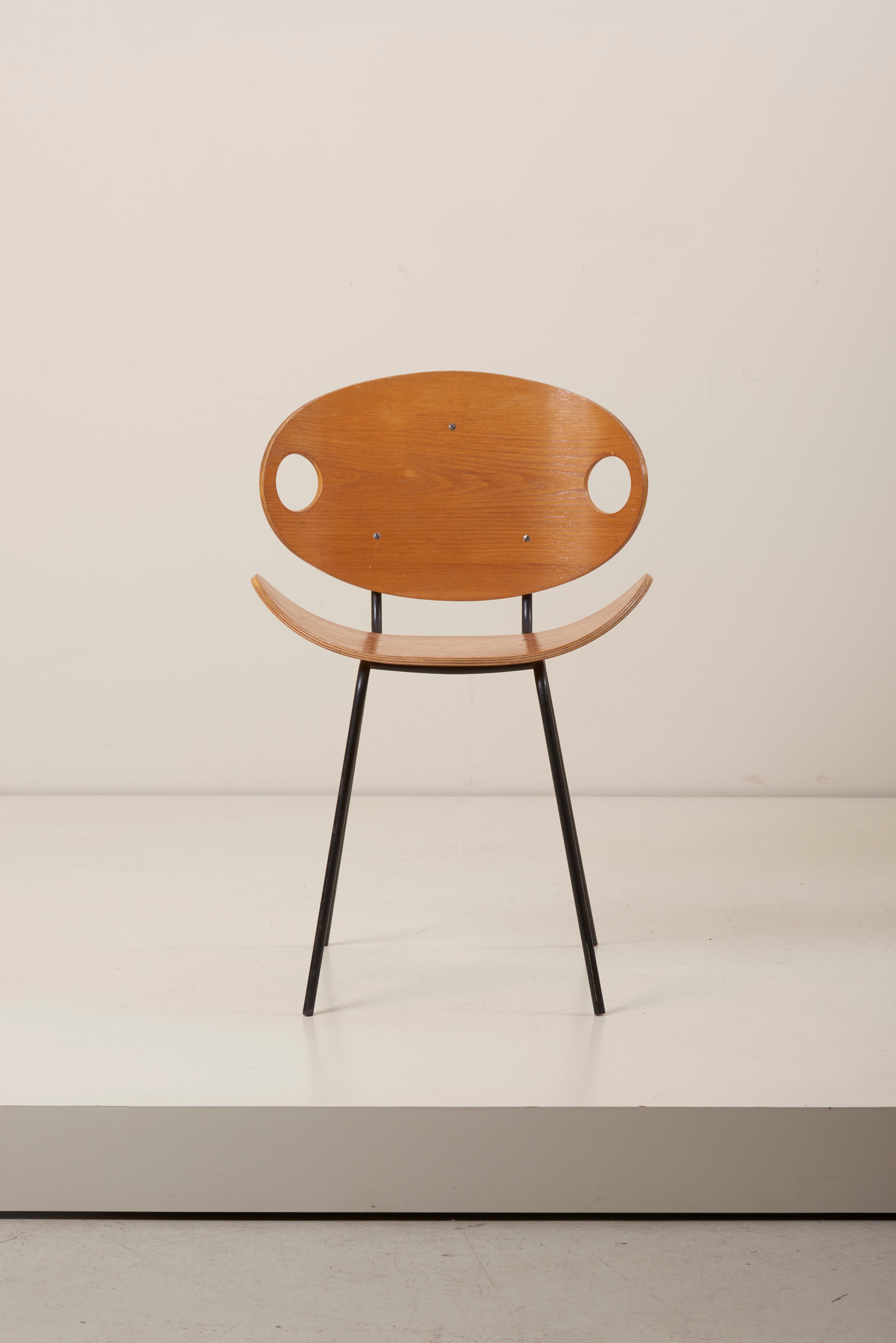 The chairs are made of four black metal legs and an ash-tree plywood seat which curves upwards. A simple and elegant design, labelled by J. Merivaara. Authentic patina.
