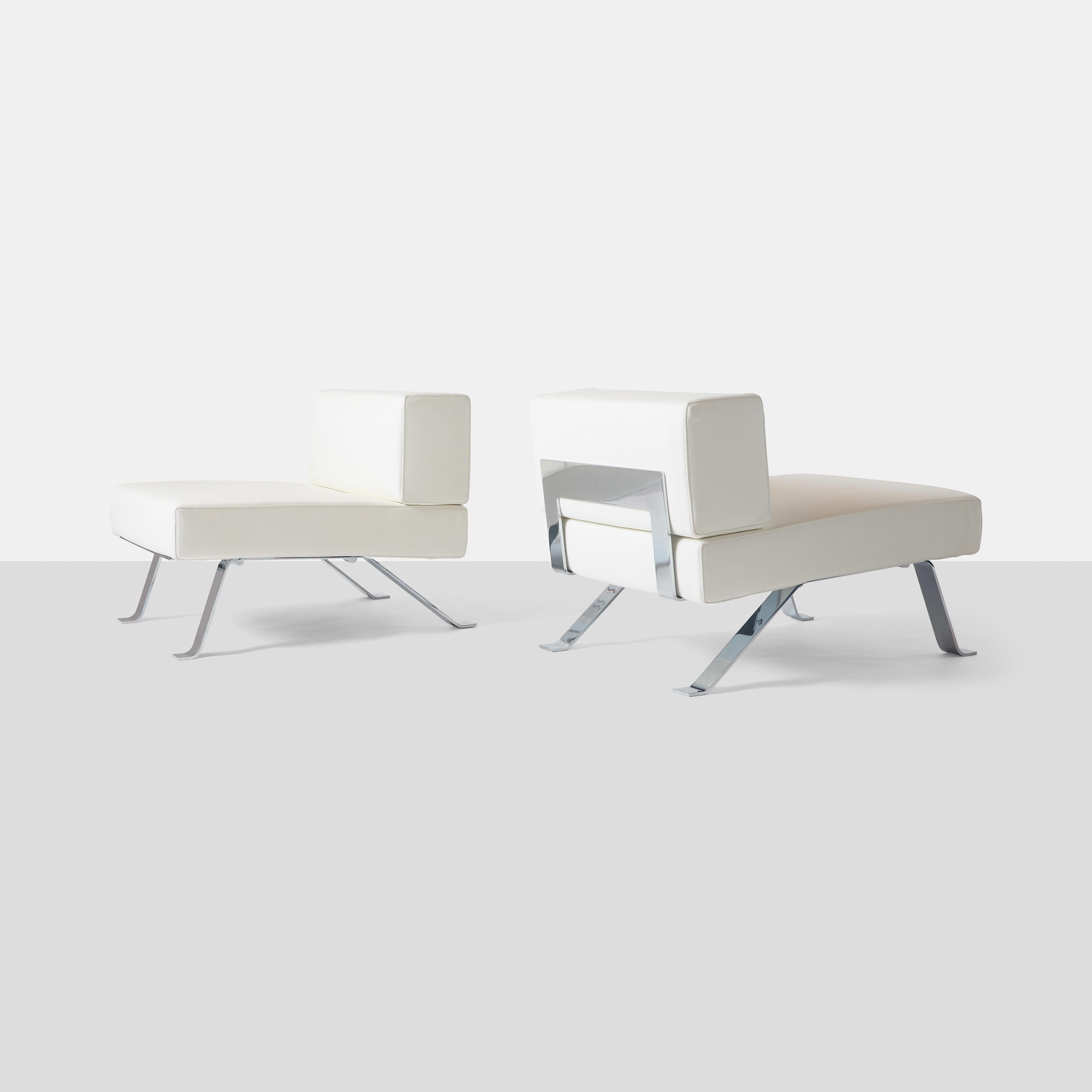 A pair of 512 Ombra lounge chairs by Charlotte Perriand for Cassina with chromed steel frames and white leather upholstery. 
Marked Charlotte Perriand Cassina Made in Italy on bottom.