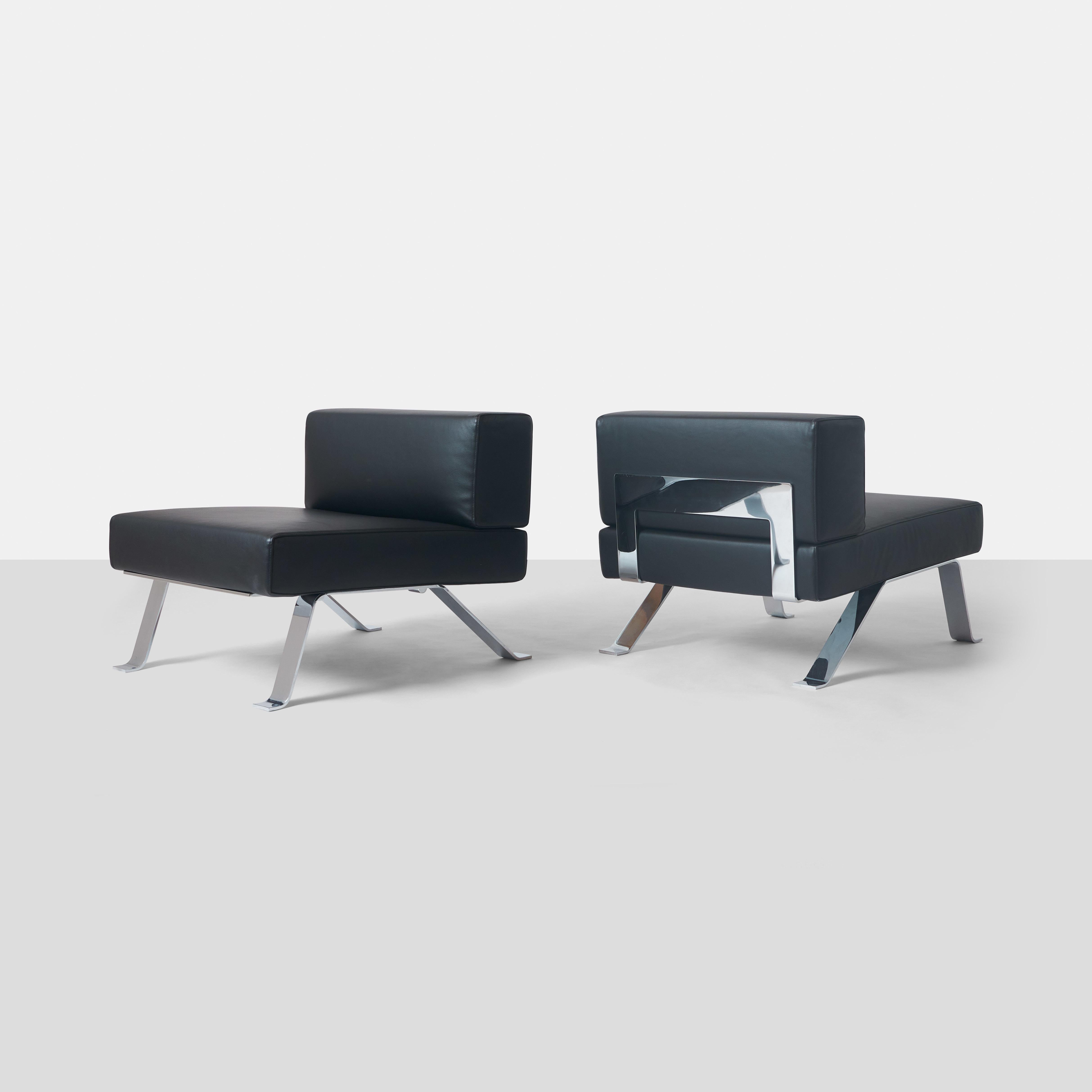 A pair of 512 Ombra lounge chairs by Charlotte Perriand for Cassina with chromed steel frames and black leather upholstery. 
Marked Charlotte Perriand Cassina Made in Italy on bottom.