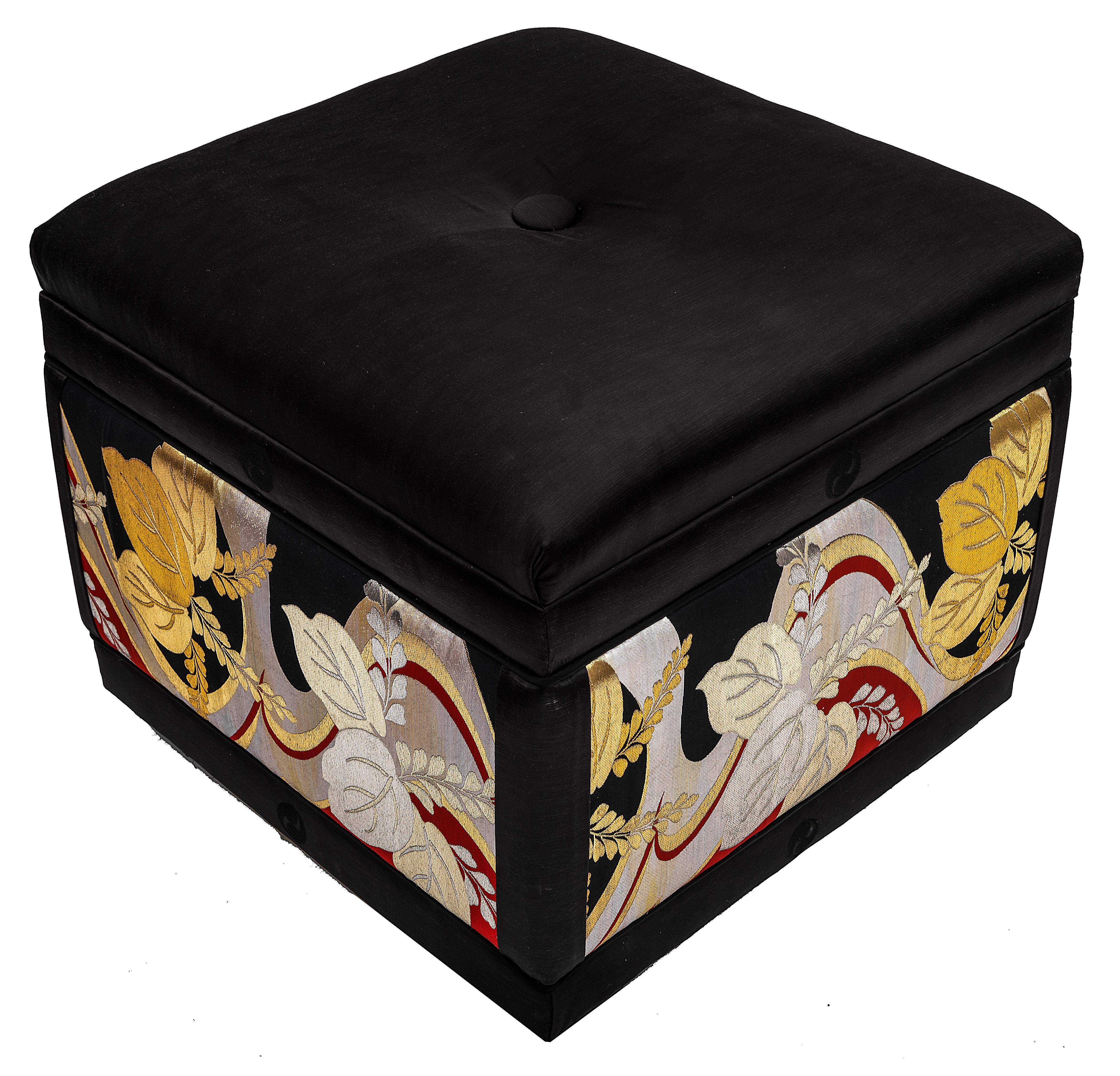 These one-of-a-kind pair of ottomans are statement pieces that add sophisticated elegance and dramatic flair to any room they inhabit. The extremely comfortable attached top cushions are covered in a black slub weave silk. The sides of each ottoman