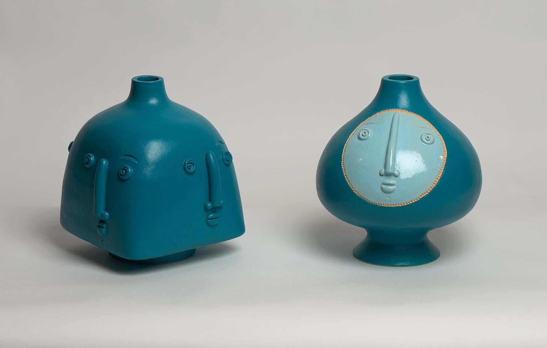 Two Hand-sculpted ceramic base lamps, stoneware glazed in Turquoise blue enamel.
One with 4 stylized faces, one with a face in a shinny clear blue enamel
One of a kind handmade pieces signed by the French ceramicists Dalo.

The height dimension