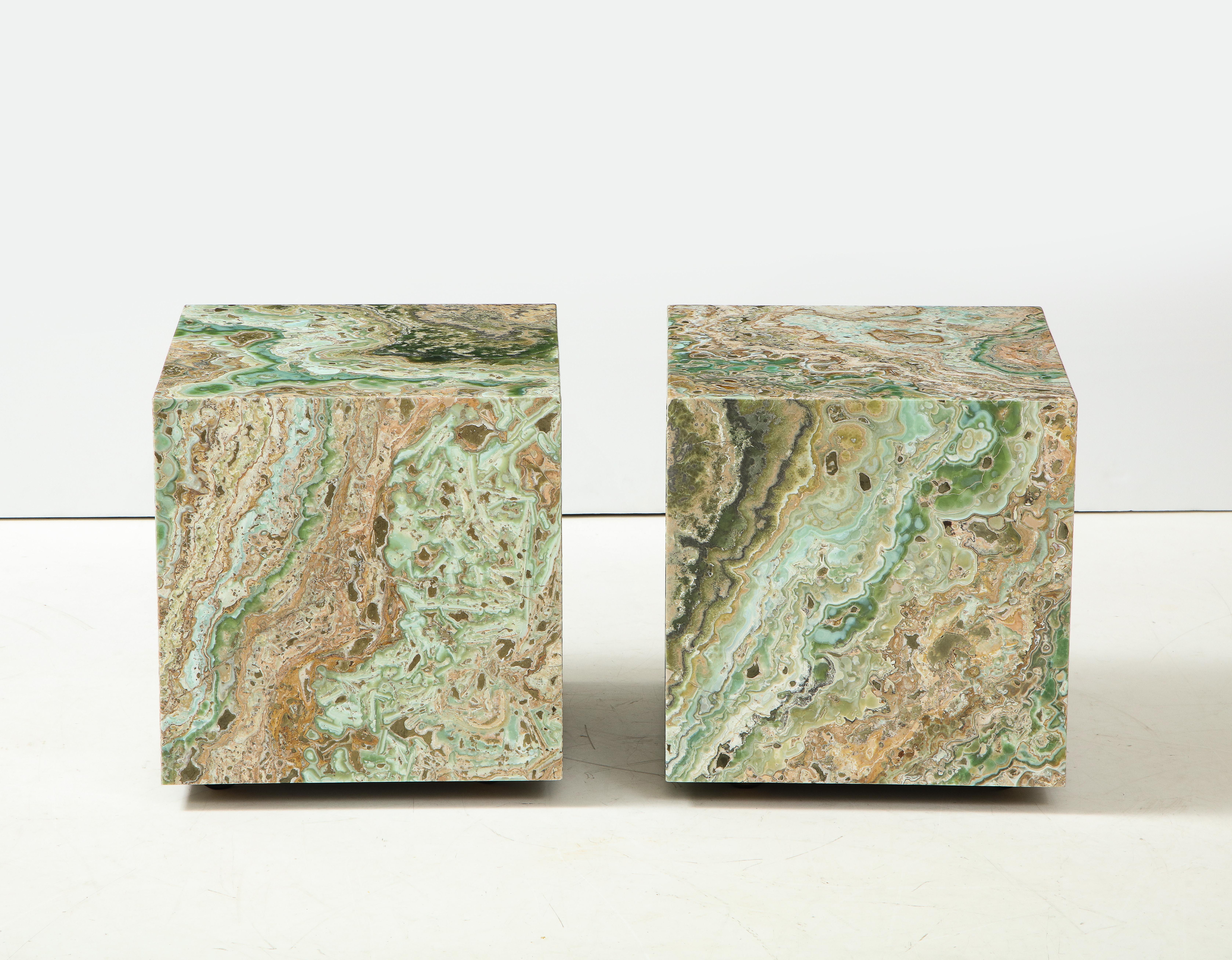 Pair of Stunning ONYX cubes that have been beautifully executed so that the pattern
follows the form.
The Beautiful polished surfaces make wonderful end tables or placed together to make a coffee table.
The cubes are set on polished brass casters