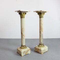 Pair of onyx pedestal columns with gilt bronze capitals and bases, 19th century