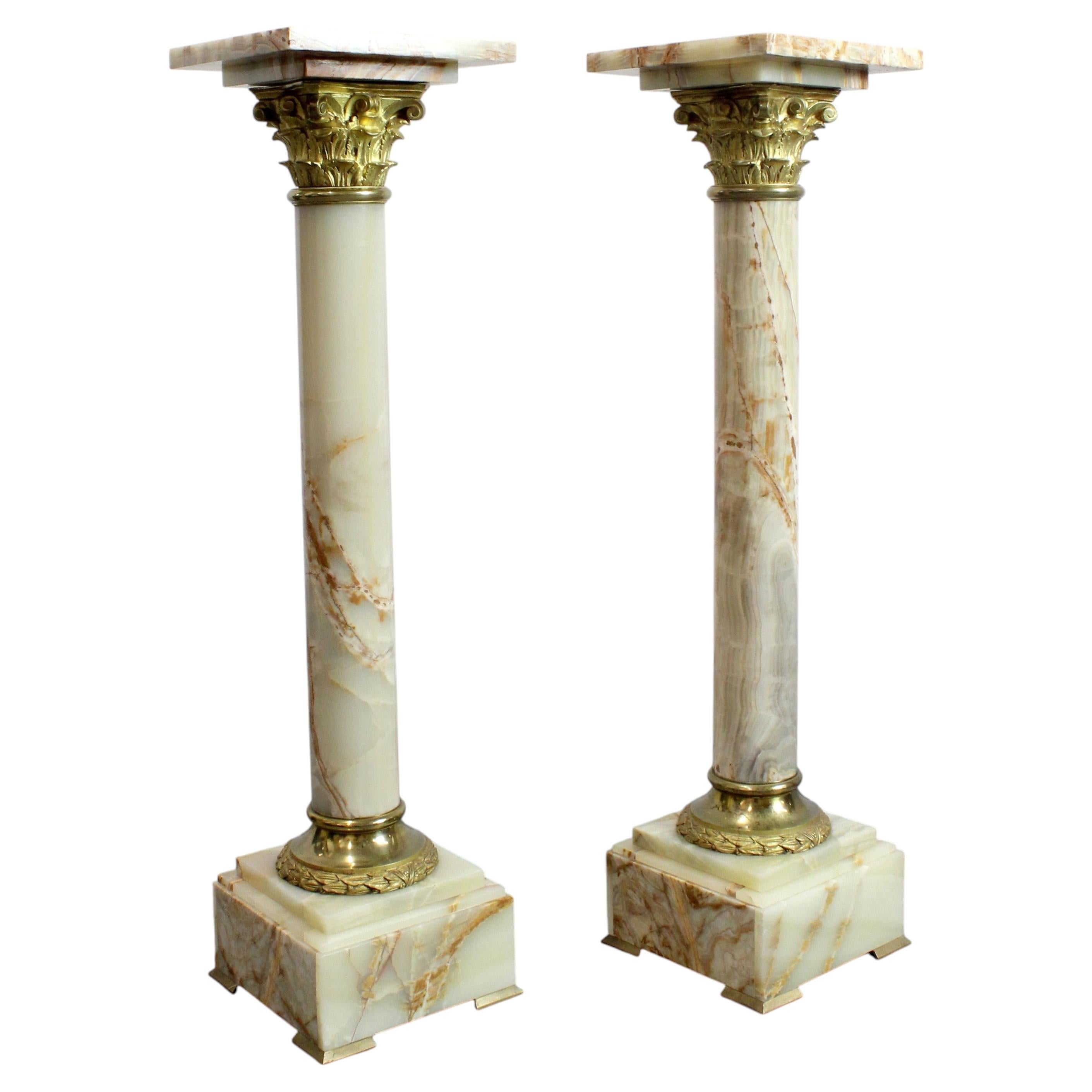 Pair of onyx pedestal columns with gilt bronze capitals and bases, 19th century