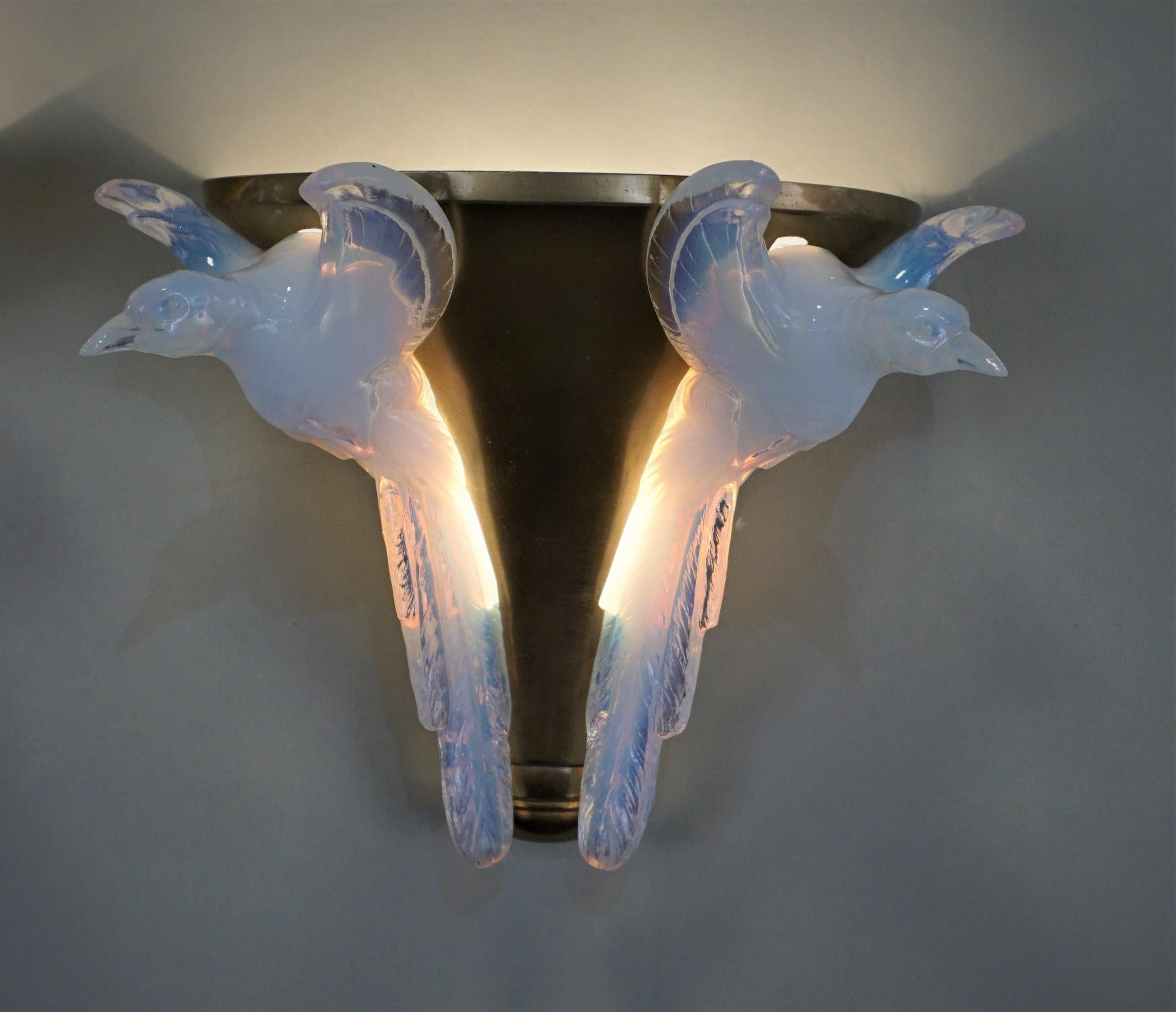 Flying bid opalescent glass and bronze wall sconces by Ezan.