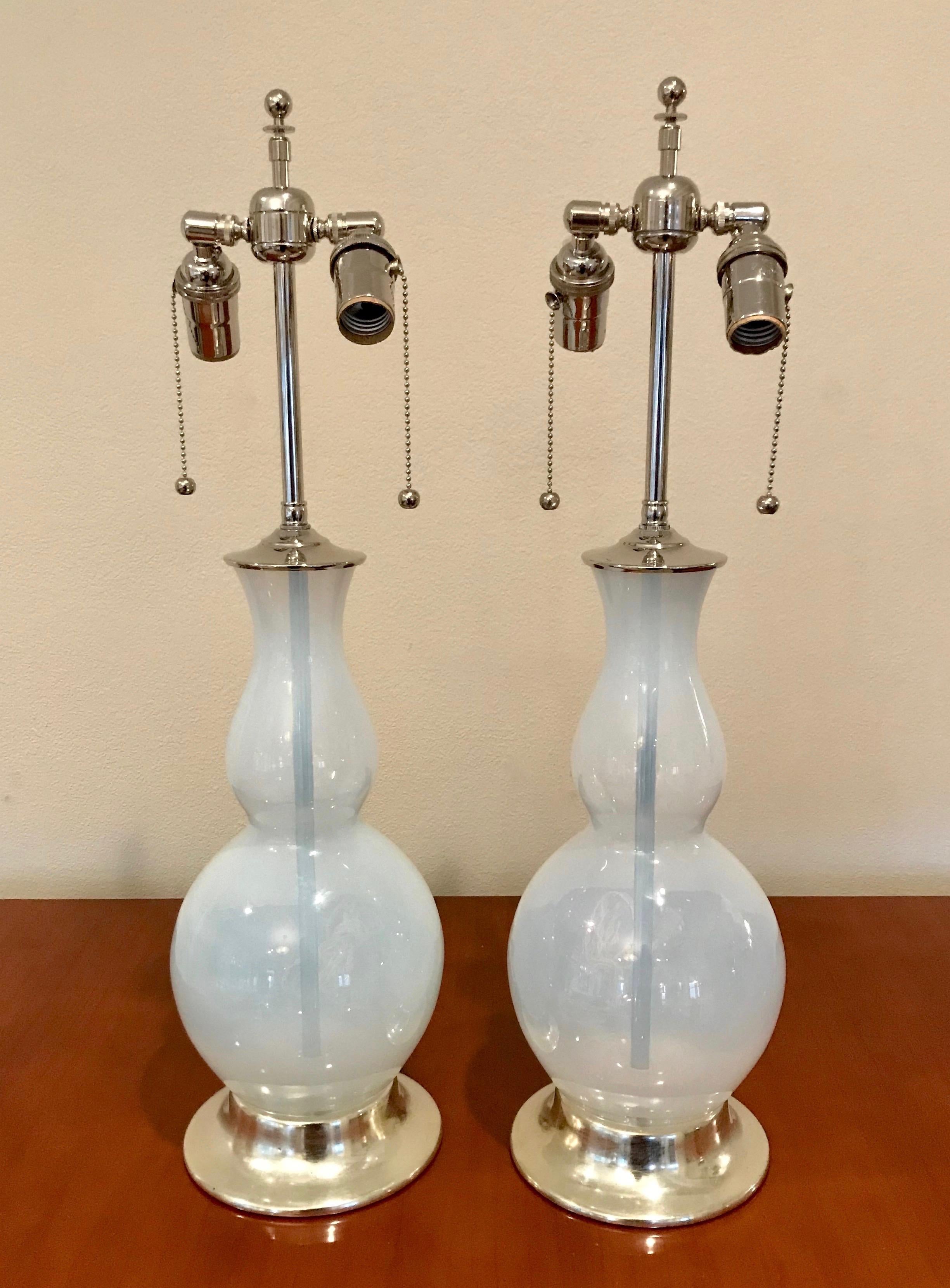 Pair of double gourd shaped opalescent Murano glass lamps on turned wood lamp bases in a 12-karat white gold water gilt finish. Nickel plated fittings with on/off double cluster sockets and French style twisted rayon covered cords. Newly wired for