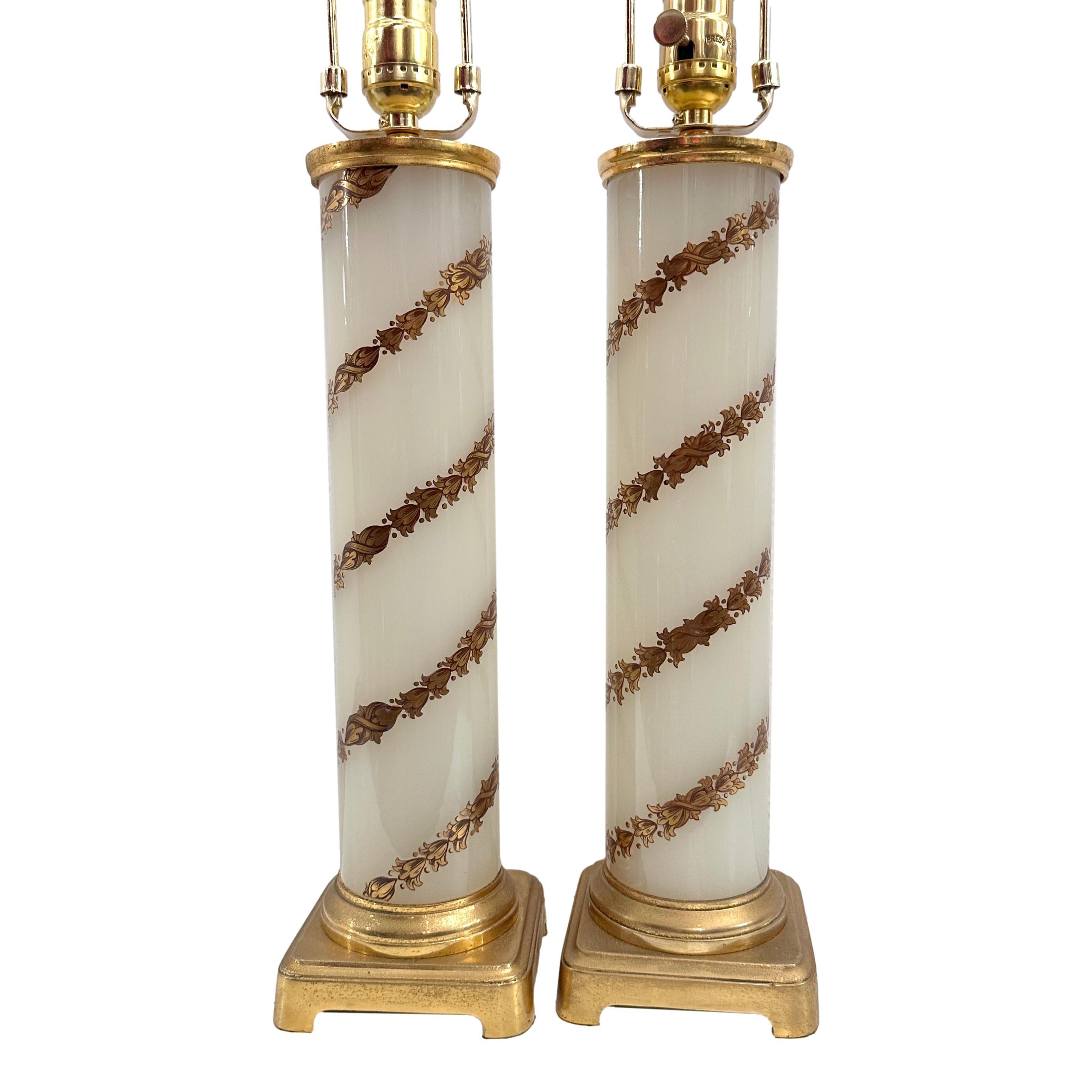 Pair of circa 1950's French white opaline lamps with gilt foliage decoration.

Measurements:
Height of body: 16