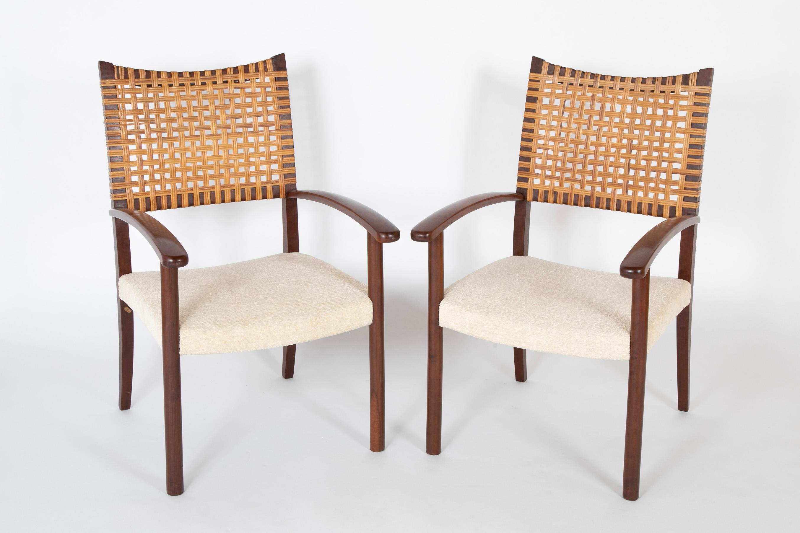 A striking pair of caned back open armchairs.  Designed in Brazil by Adolfo Foltas