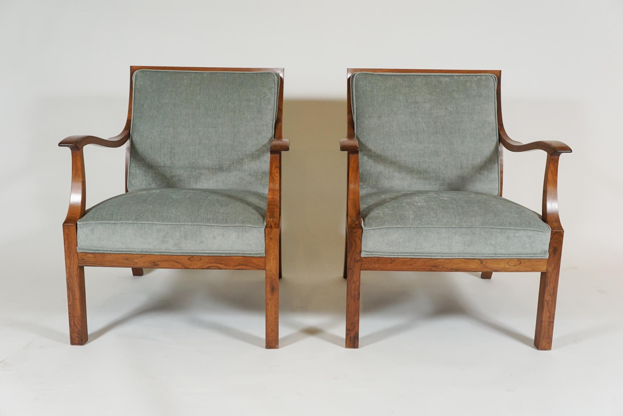 Pair of handsome open armchairs by well-known Danish designer, Frits Henningsen, who achieved high standard of quality with exclusively handmade pieces. In mellow rosewood from 1960s newly upholstered in a pale blue velveteen fabric.