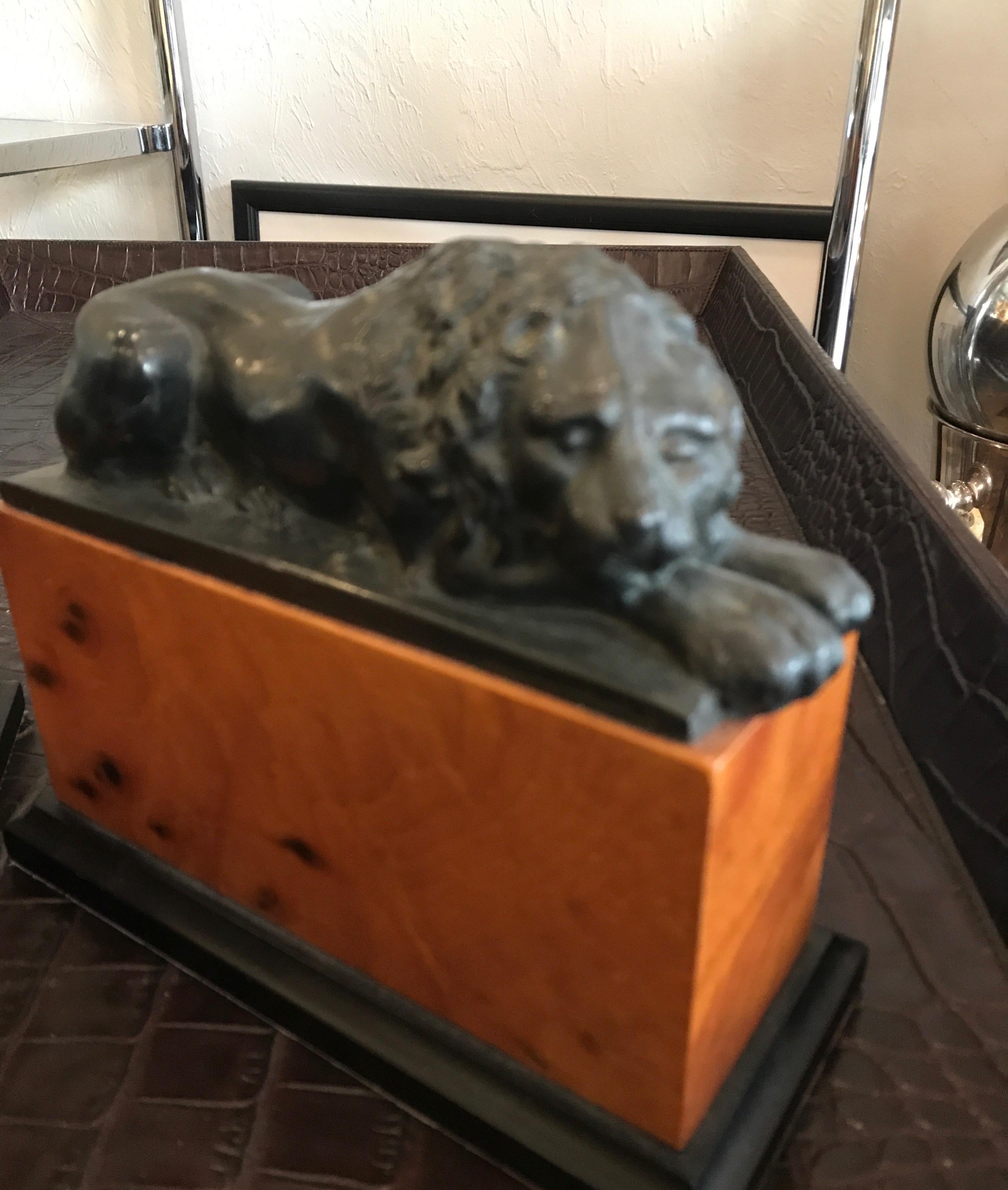 Pair of opposing lion bookends on burlwood bases.