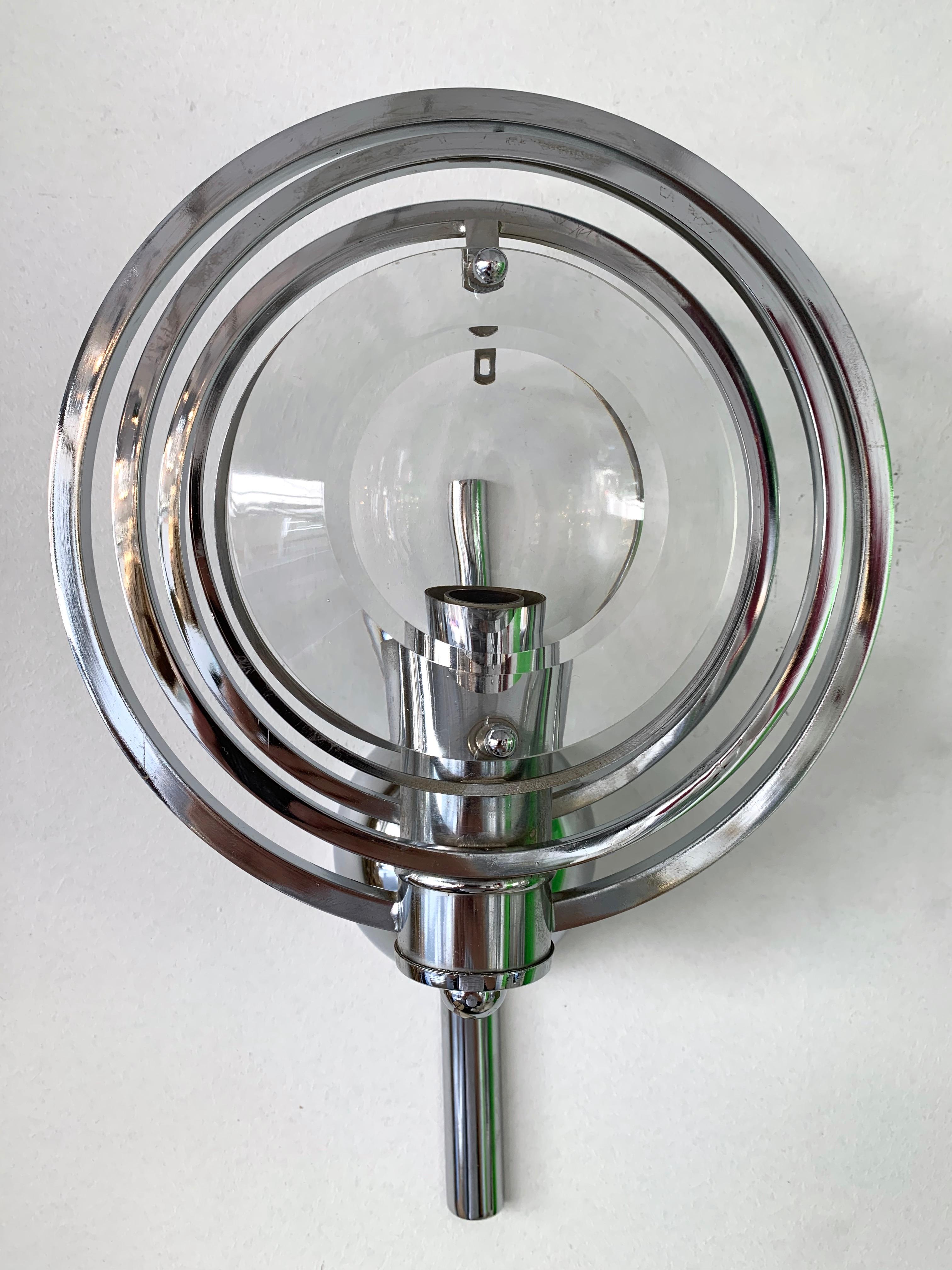 Pair of optical glass and metal chrome wall lights lamps sconces by Oscar Torlasco. The circles are adjustable and rotable.

2 pair available. Price listed by pair.