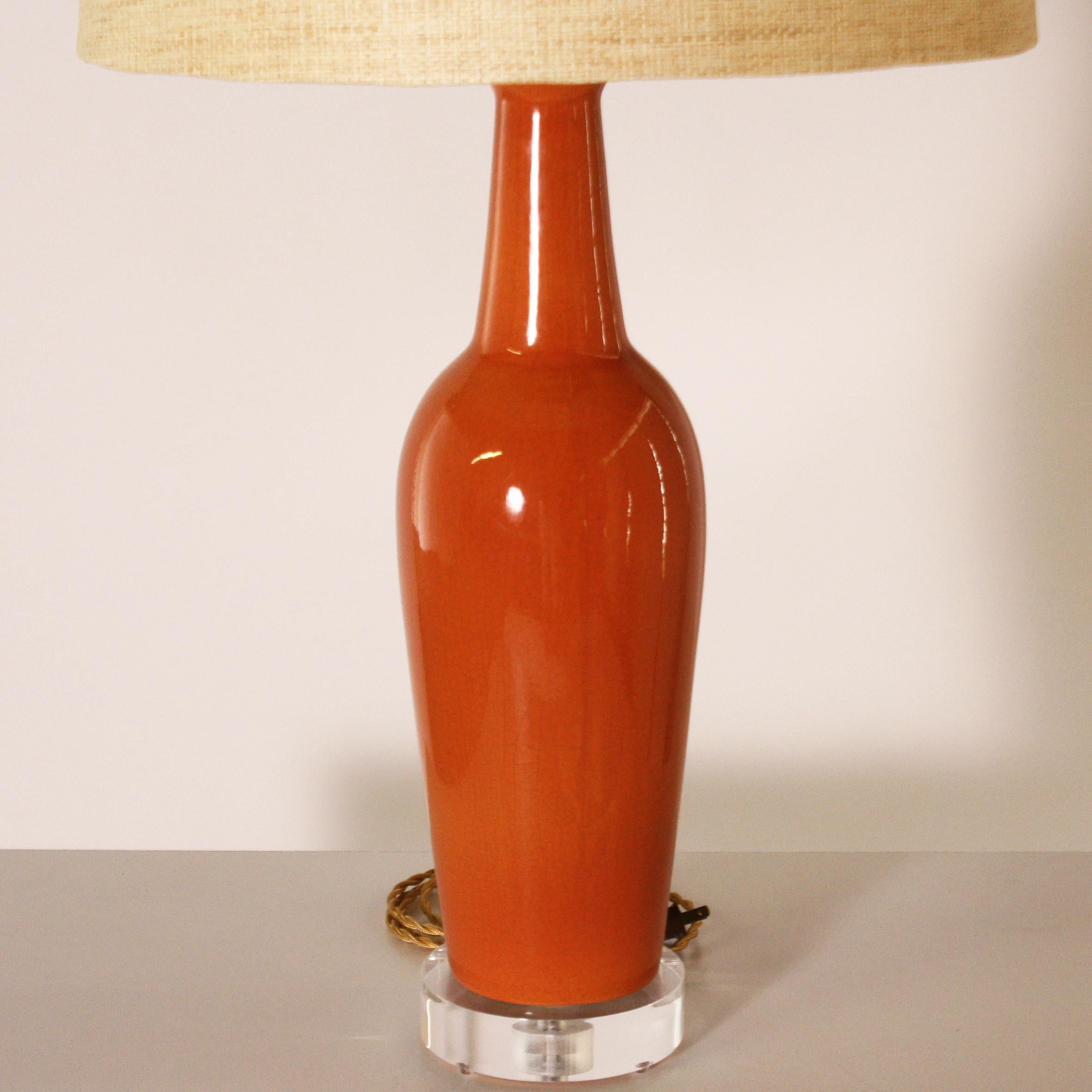 Pair of orange ceramic ginger jar lamps, circa 1940.
Measures: 18” diameter x 27” height.