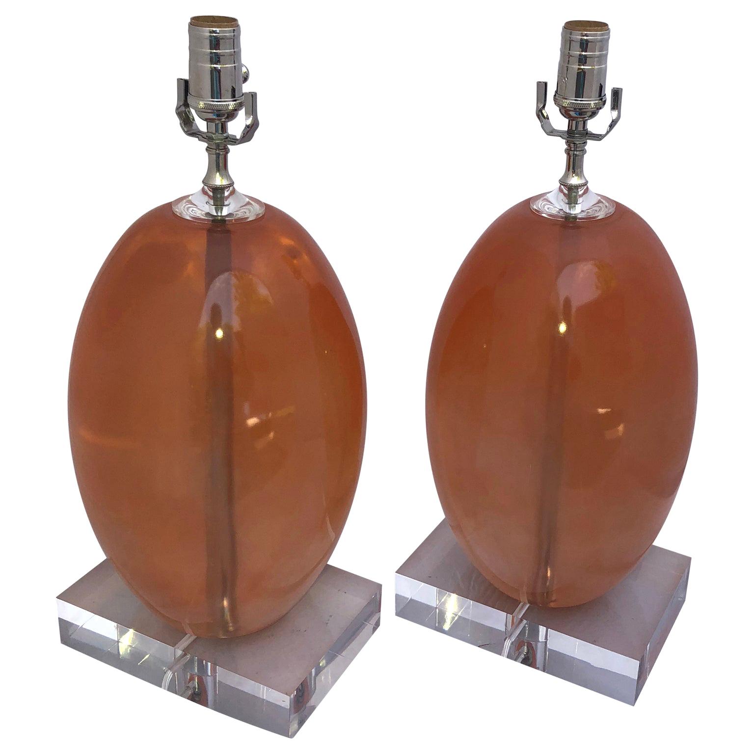 Pair Of Orange Ellipse-Shaped Resin Table Lamps On Thick Lucite Base For Sale