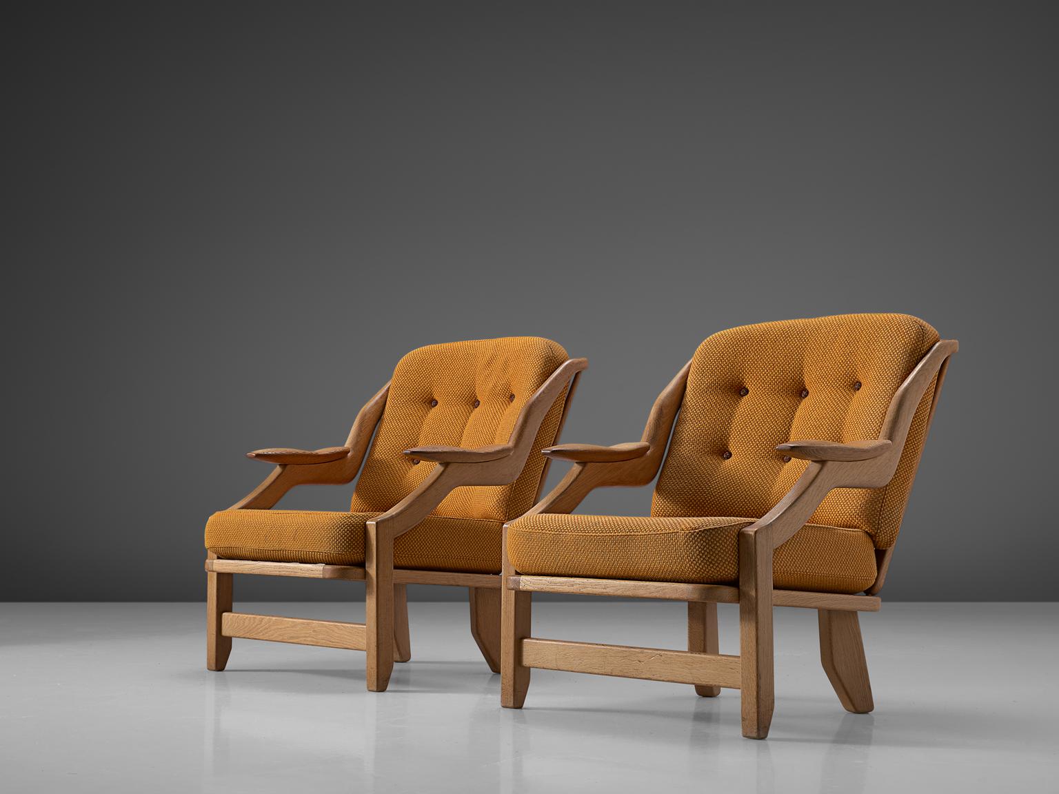 Guillerme and Chambron, pair of lounge chairs, orange fabric and oak, France, 1950s. 

This French designer duo is known for their extreme high quality solid oak furniture, from which this orange set is another great example. These chairs have a