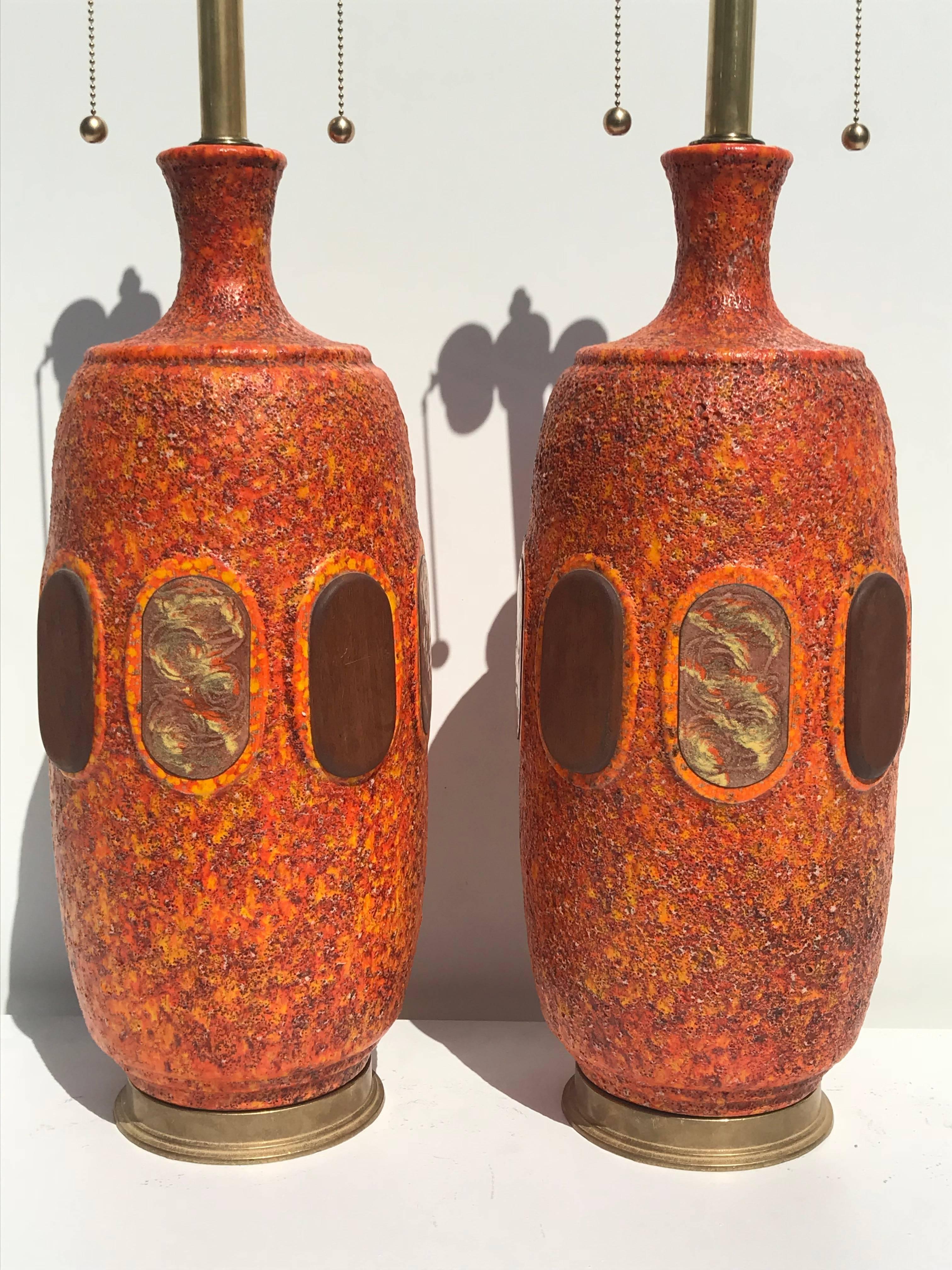 Pair of orange lava glazed ceramic lamps in the style of Marbro. 
Shades are not included.

Offered at Gallery Girasole in North Hollywood