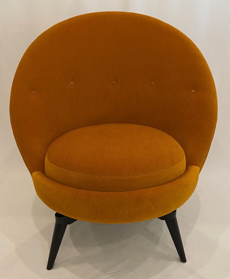 Swivel egg chair in the French Midcentury style. This sophisticated chair is upholstered in luxurious heavy weight, Muslin backed Orange/Ochre knit Mohair. This super stylish and versatile example is as comfortable as it looks and is painstakingly