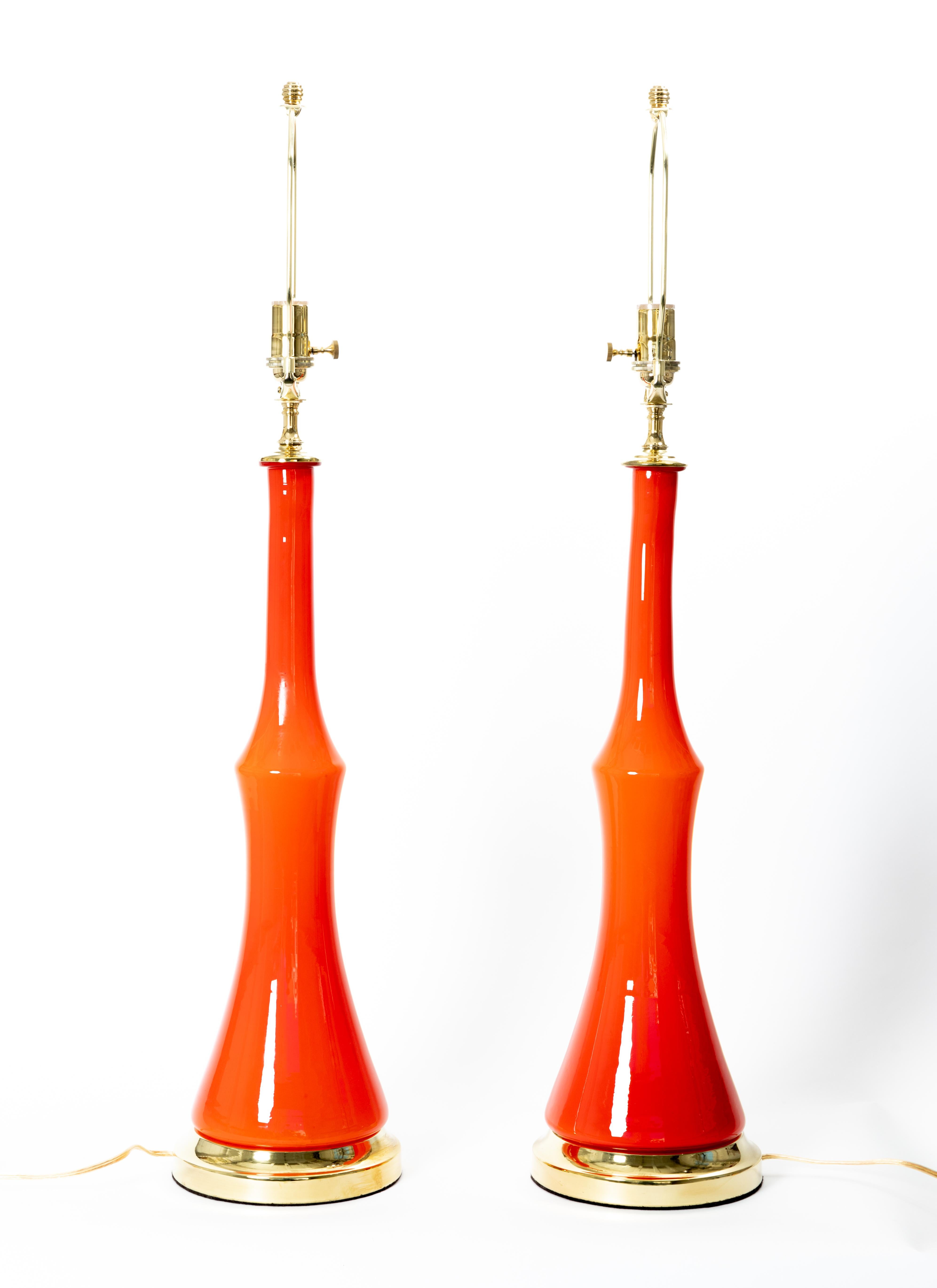 Pair of orange Murano glass table lamps with brass detail.