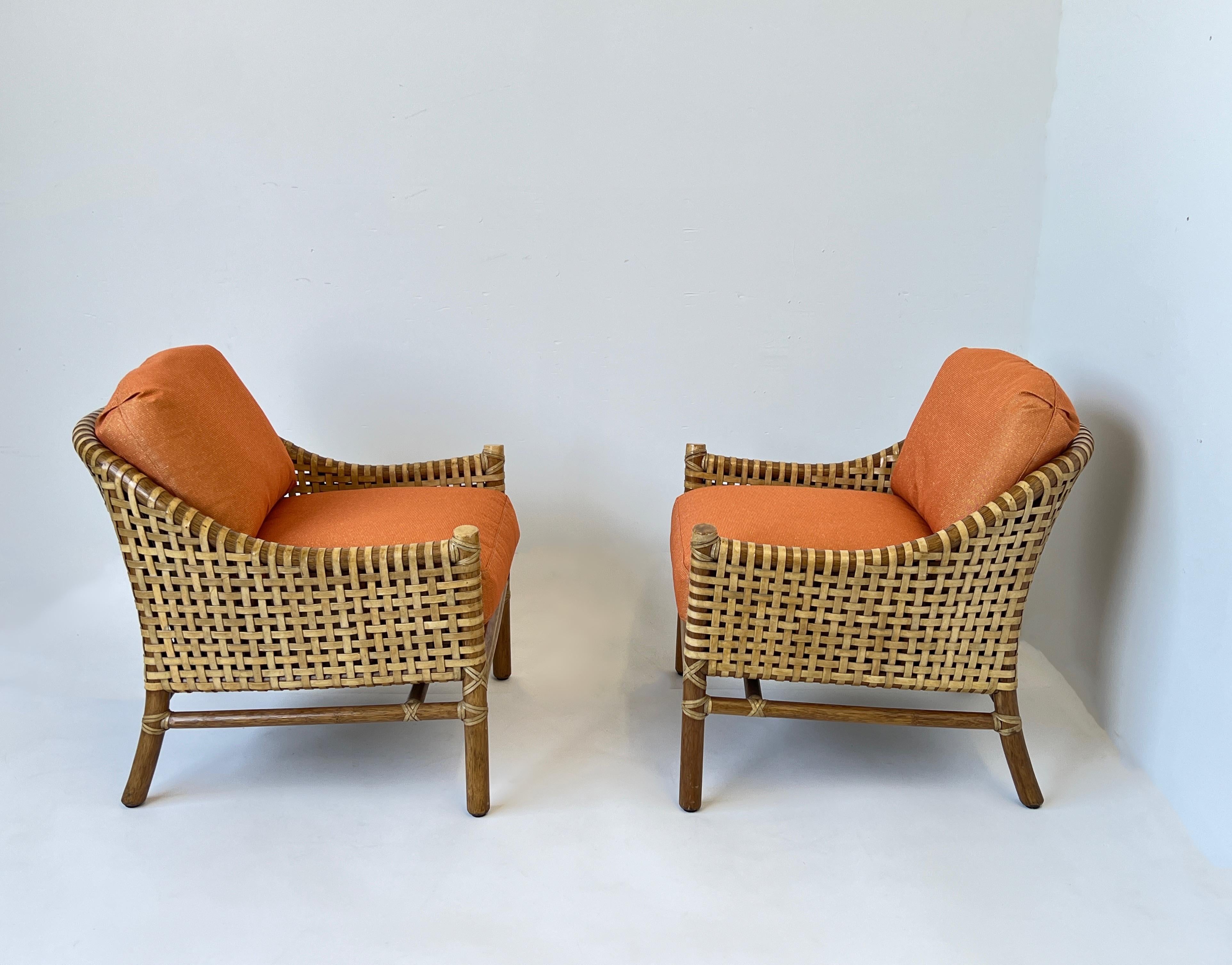 American Pair of Orange Rattan Bamboo and Rawhide Lounge Chairs by McGuire