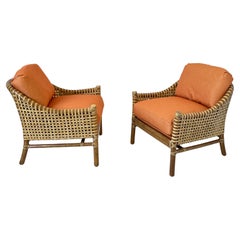 Pair of Orange Rattan Bamboo and Rawhide Lounge Chairs by McGuire