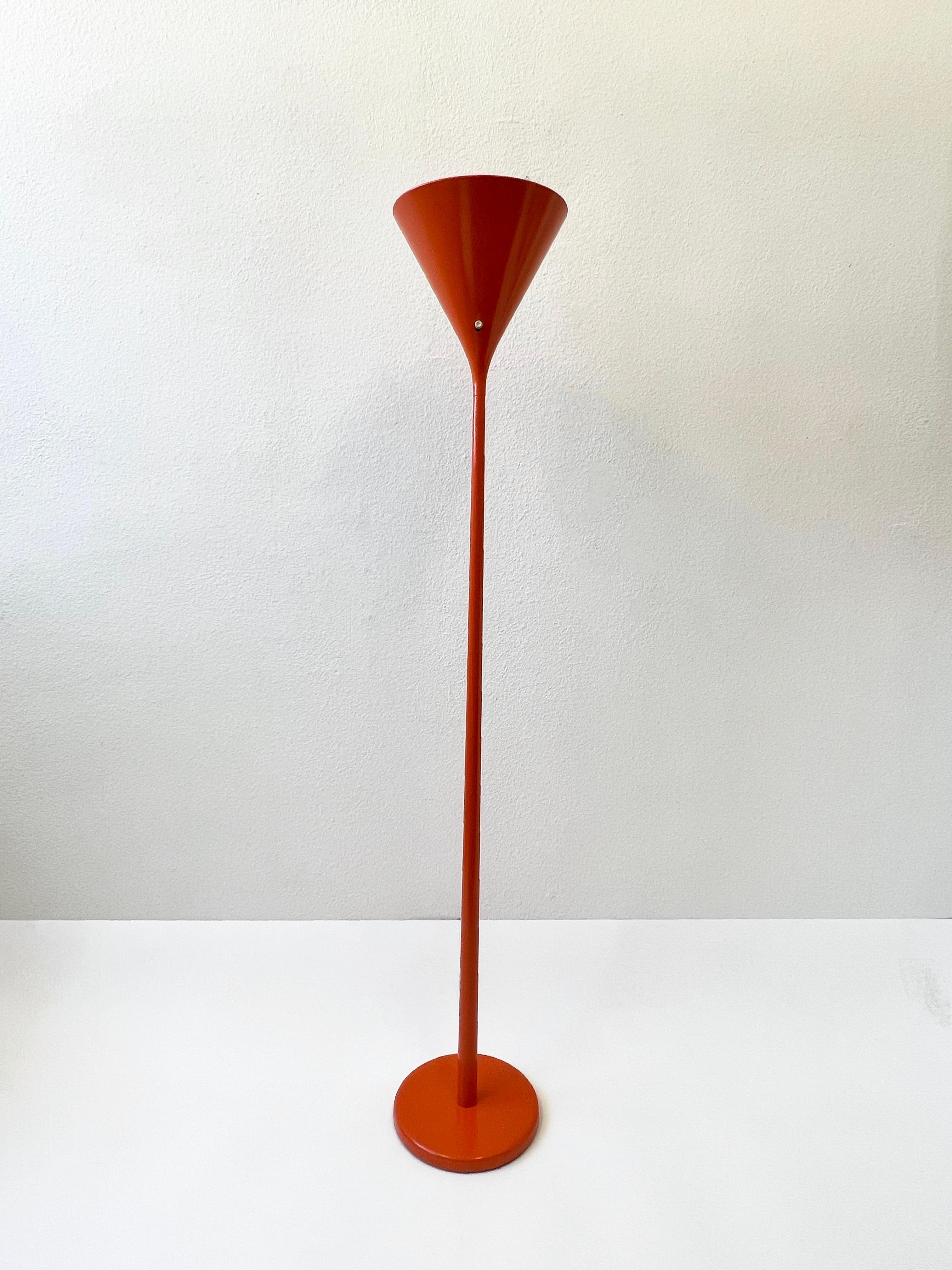 Pair of 1960s orange torchiere floor lamps by Walter Von Nessen. 
Newly powder coated and rewired.
Rotating On/Off switch on shade. 
It takes one 100w Max Edison lightbulb. 

Measurements: 64.5” High, 11.25” Diameter.