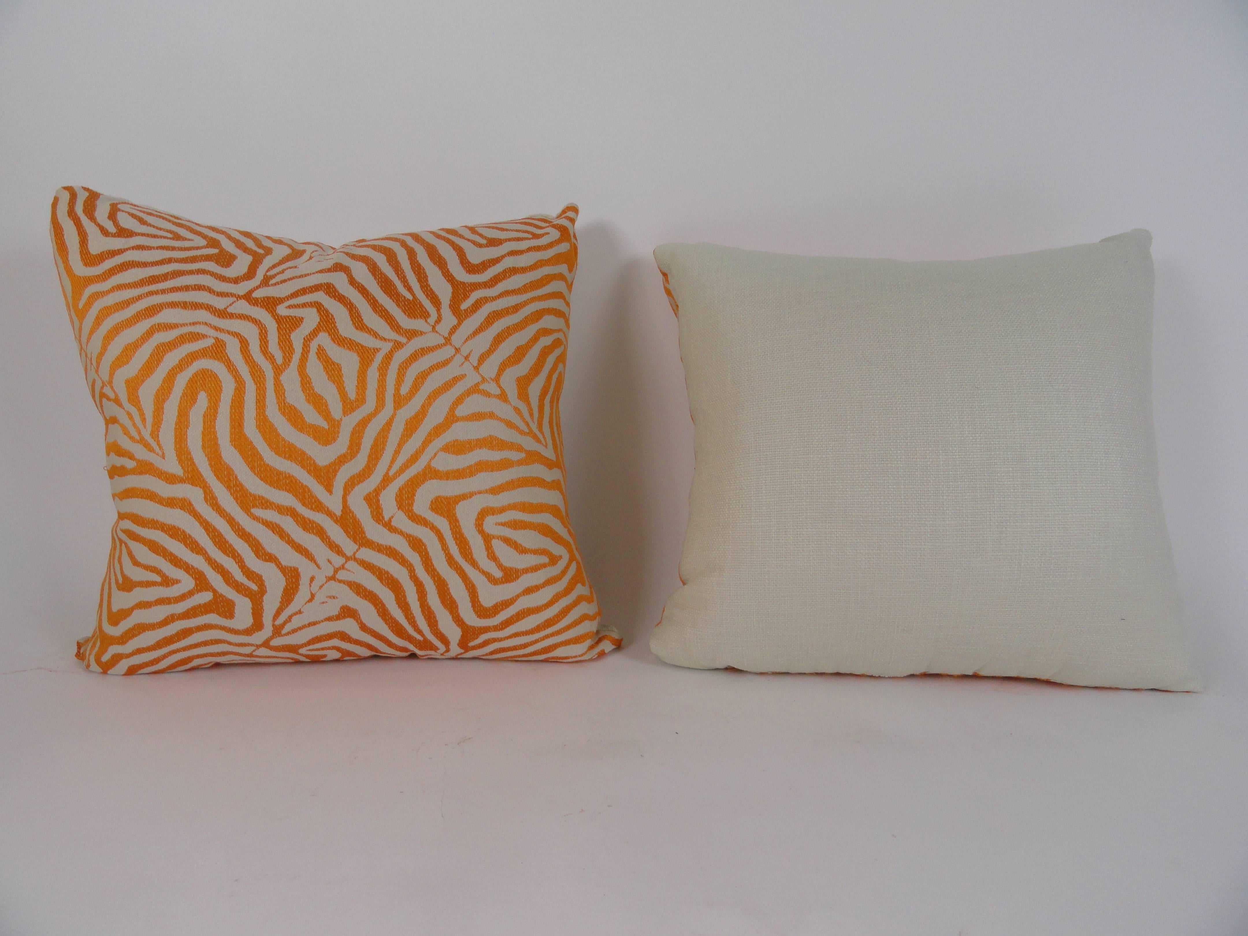 Pair of orange and beige zebra print pillows with beige cotton backing. 80/20 down filled. 24