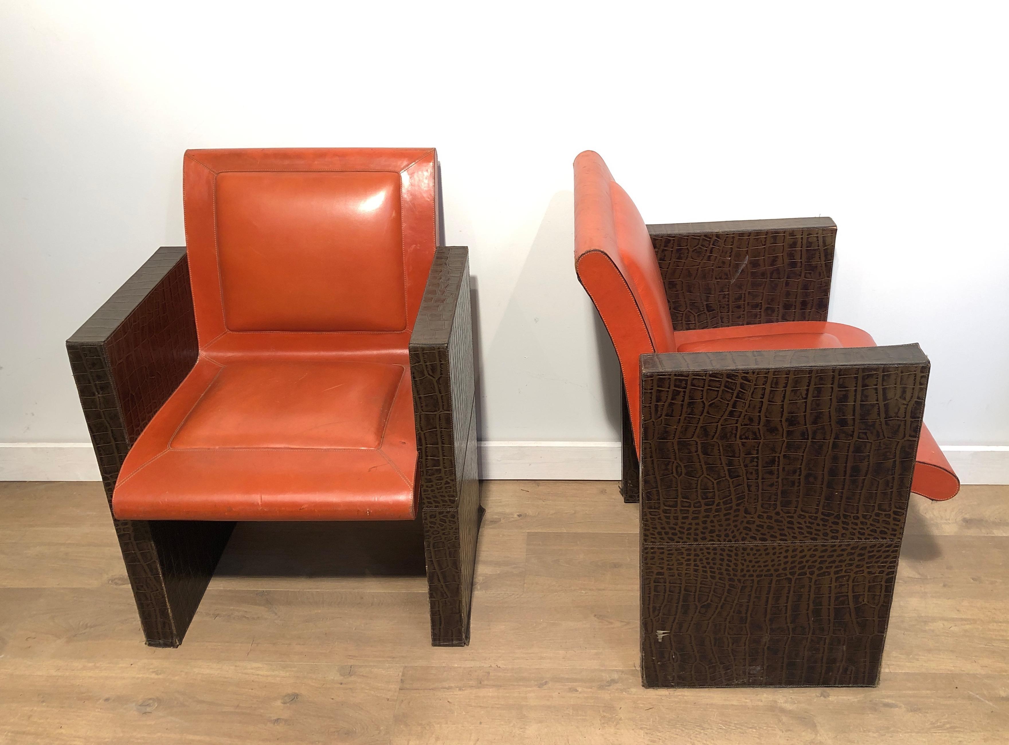 Mid-Century Modern Pair of orangeish and brown leather armchairs (Can be sold individually).  For Sale