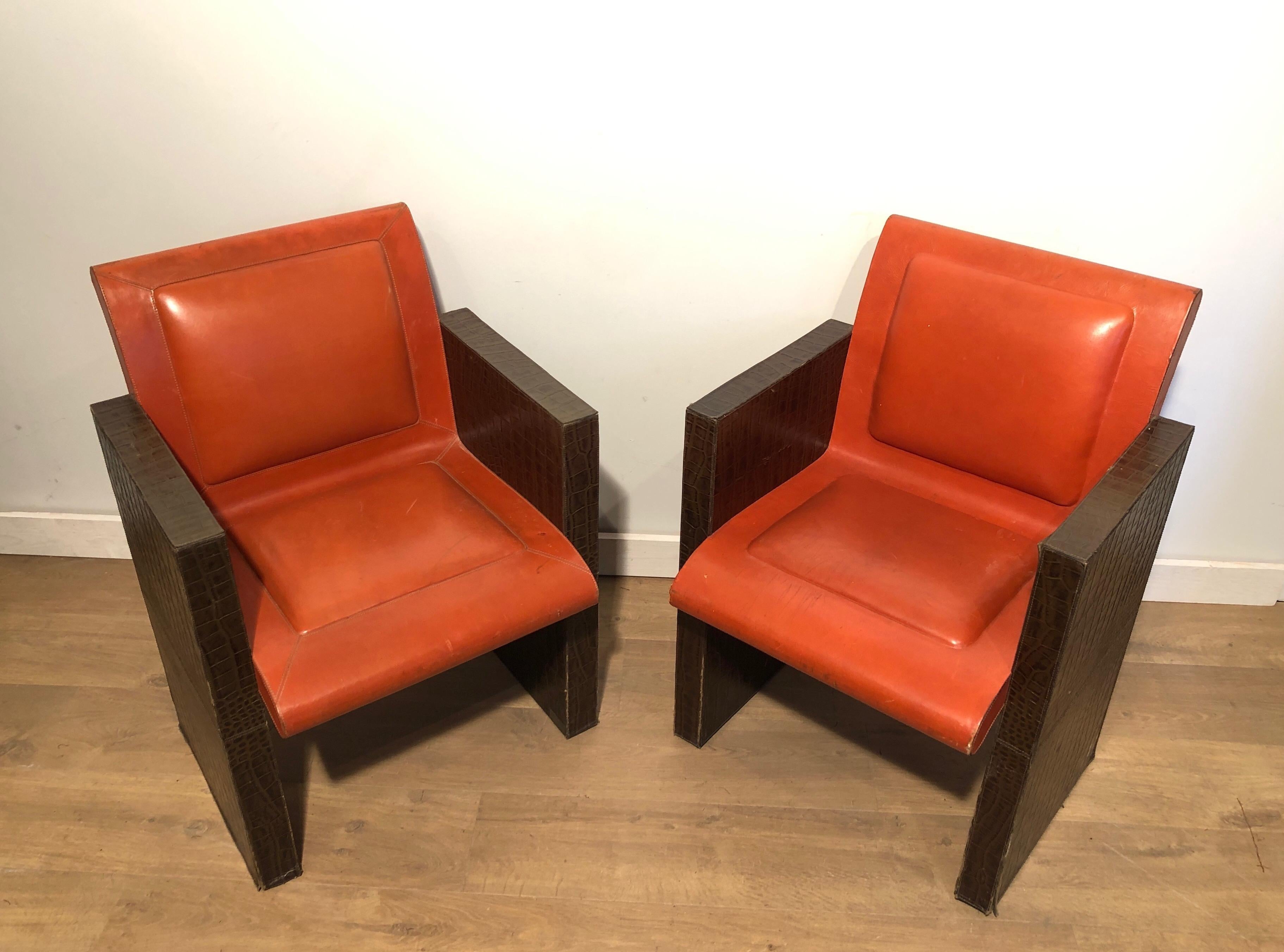 This very unusual armchairs are made of an orangeish and brown leather. The armchairs can be sold individually. We have 3 of these available. This is a French work. Circa 1970
