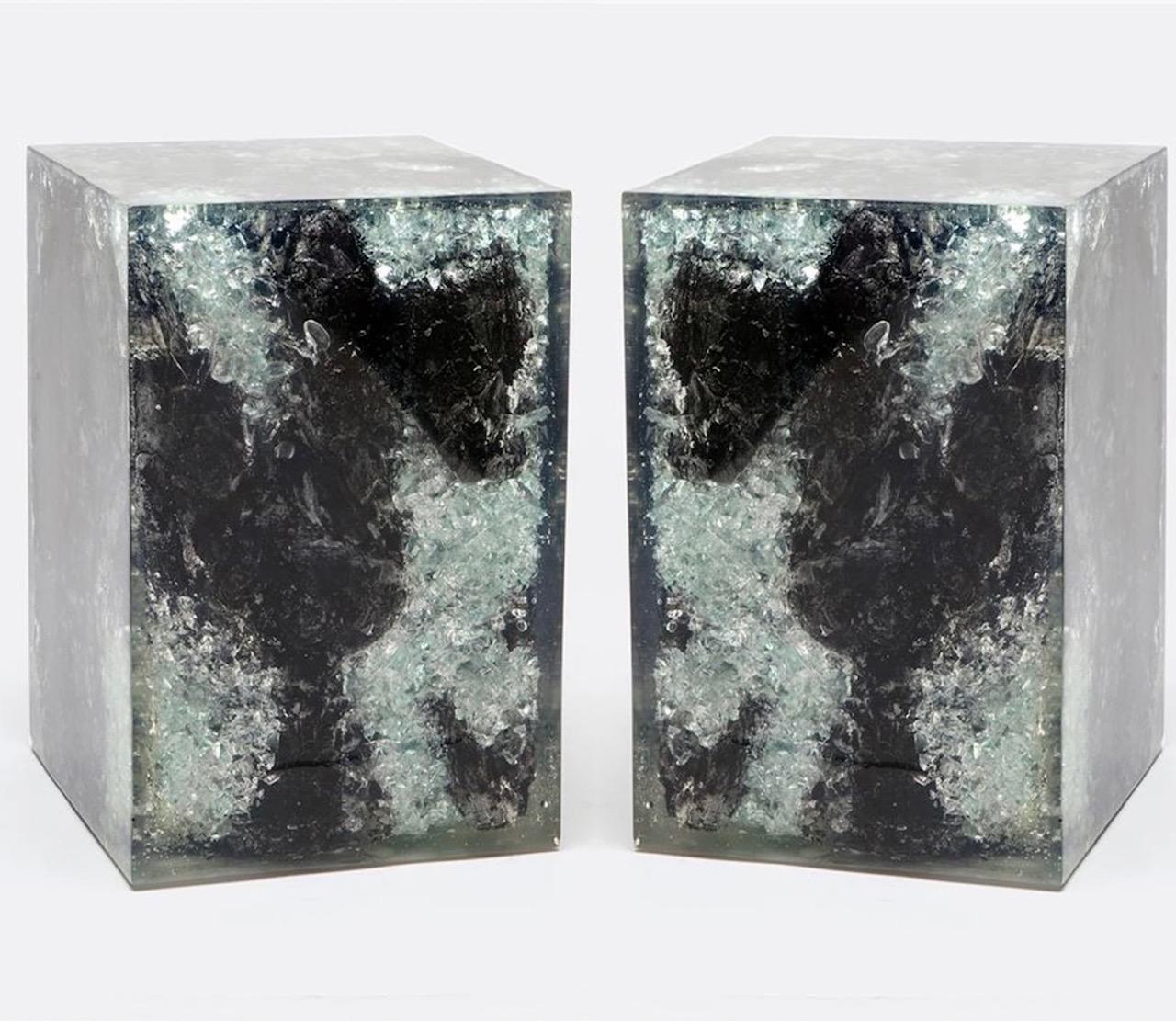 Pair of organic modern accent tables in burnt exotic teak, resin, and crystals. The tables have a polished finish with unique wood variations on all four sides. Handcrafted and multipurpose use as table or stool. Expect variation in colors as each