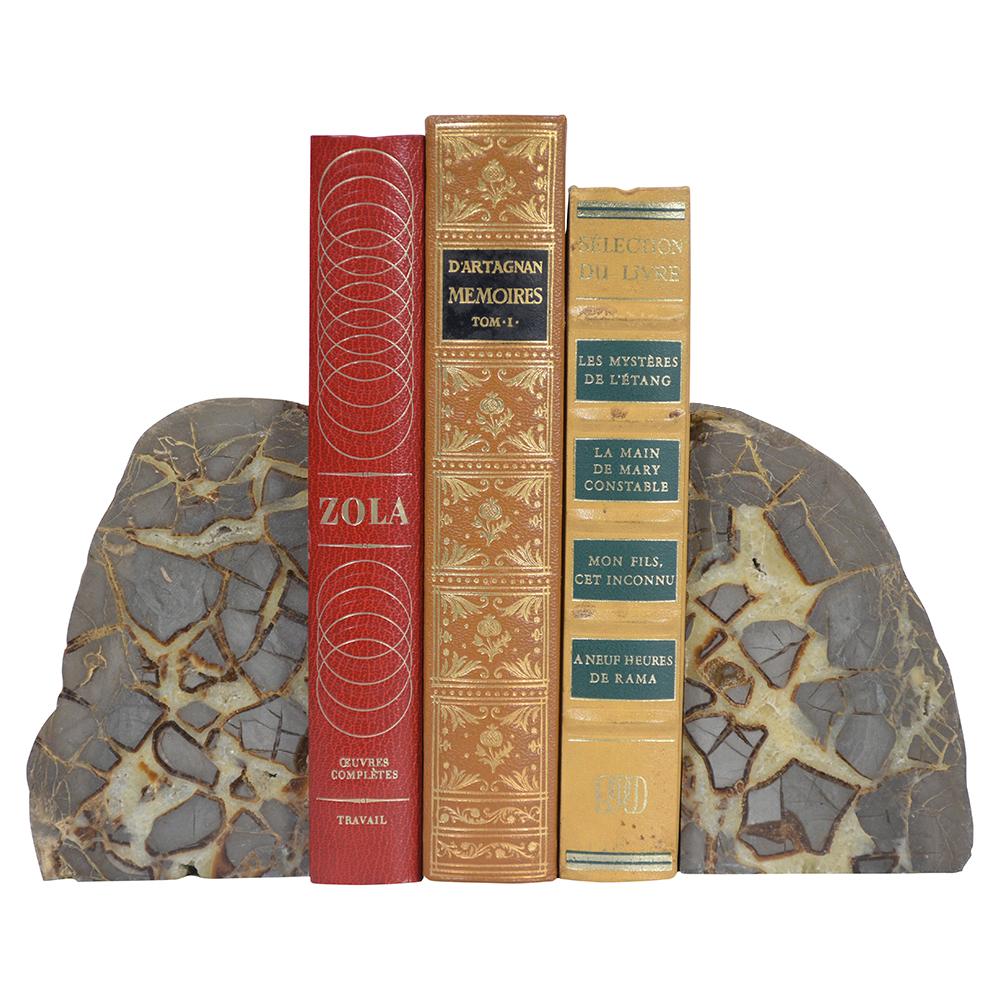 A pair of organic modern bookends crafted out of marble featuring a unique design perfect addition to a home or office space, books are not included.
