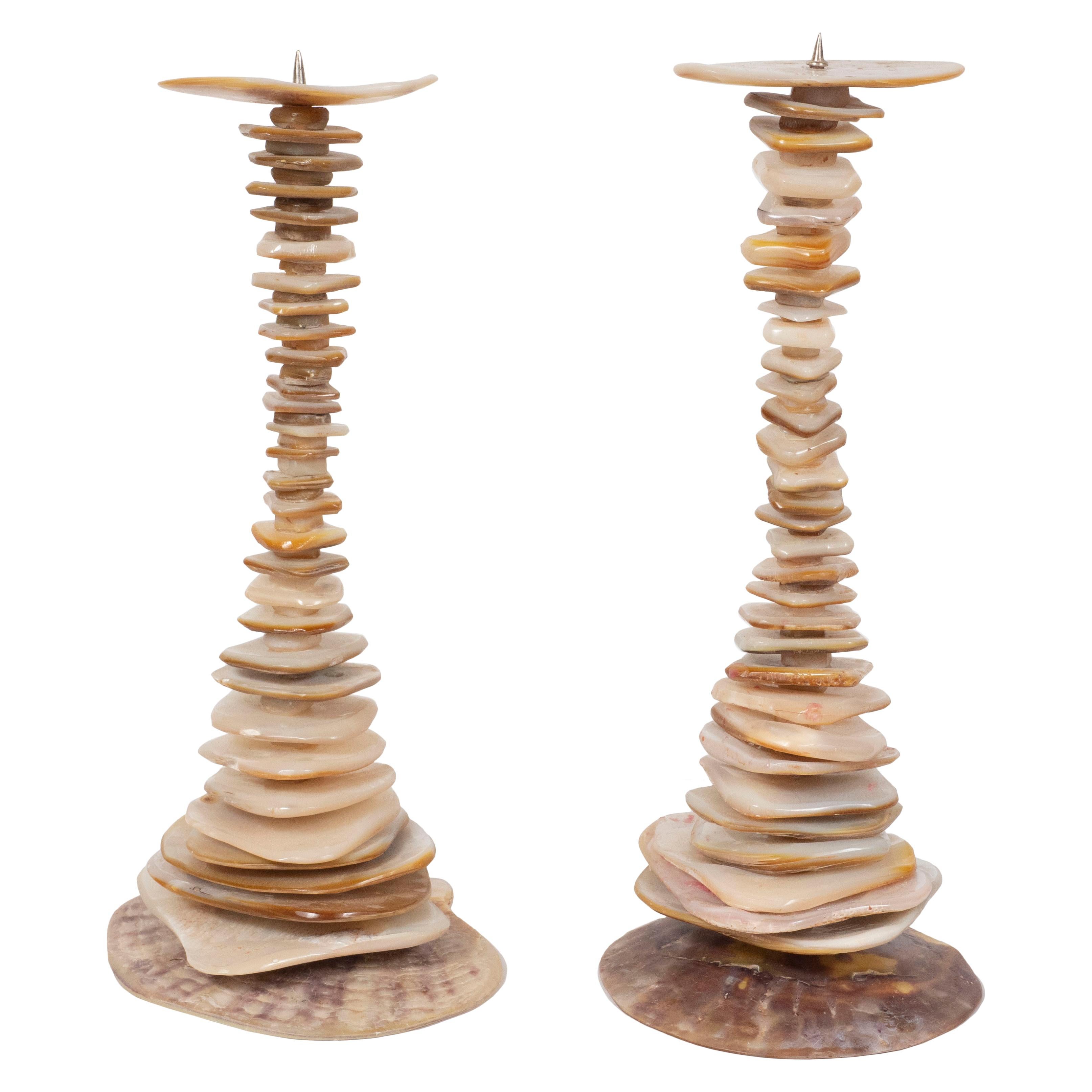 This elegant pair of organic modern candlesticks were realized in the Phillipines. They feature an hourglass form composed of an abundance of organically formed abalone fragments offering a variety of natural hues. With their naturally sophisticated
