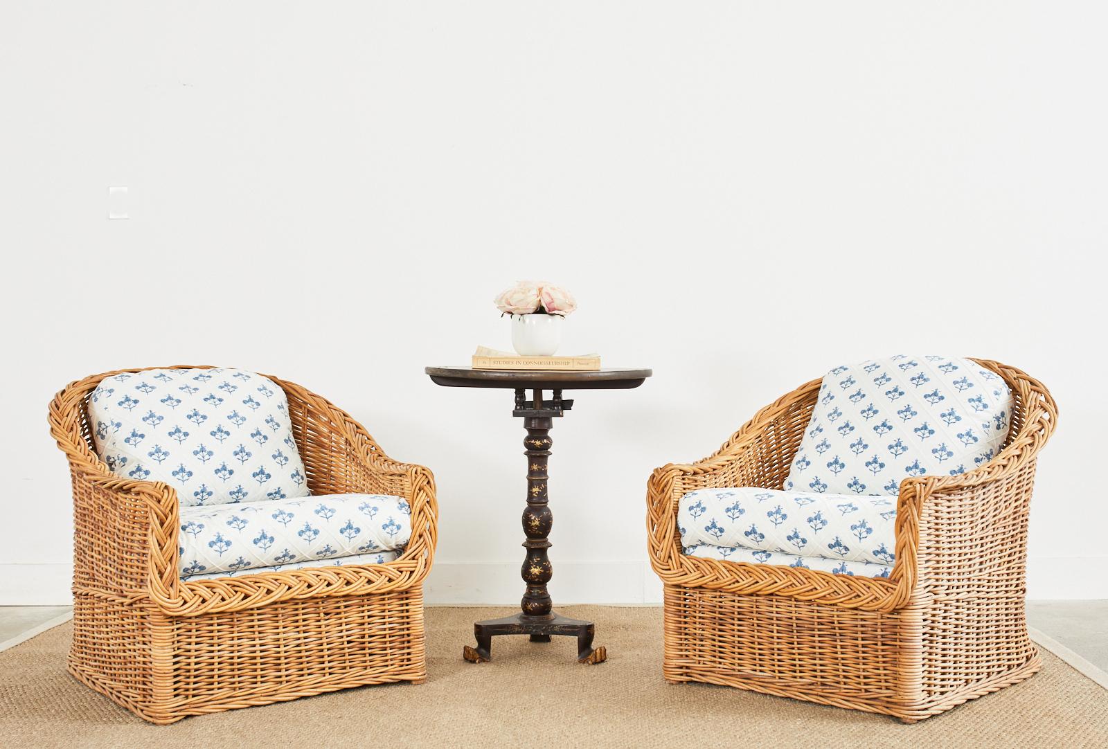 Stylish pair of woven rattan wicker lounge chairs made in the California organic modern style by The Wicker Works in San Francisco. The timeless design features a modern redux of blue and white upholstery. The fabric has a geometric diamond pattern