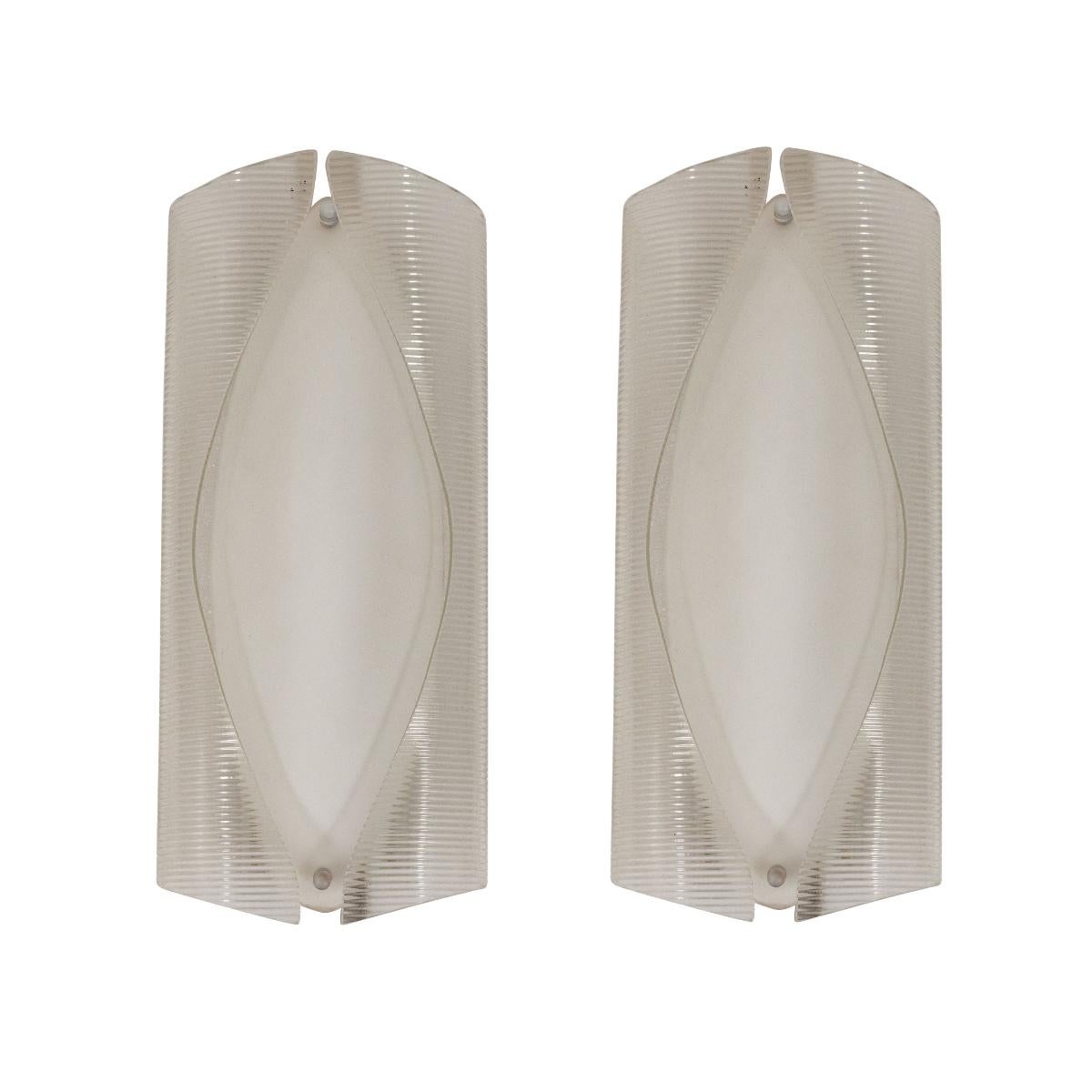 Pair of organic sculptural glass sconces with layered clear and white glass shades.