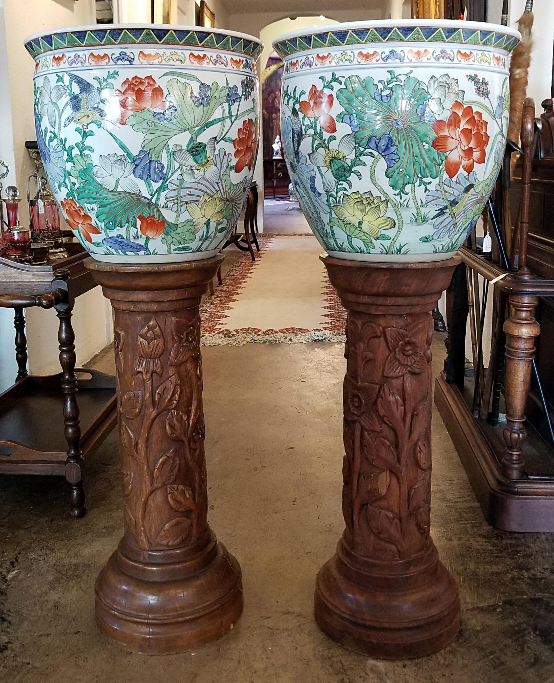 Presenting a stunning pair of oriental fish bowls made for Gumps of San Francisco on solid hand carved, floral, French walnut jardinières.

The fish bowls are probably mid-20th century and are fully marked. Chinese export specifically for