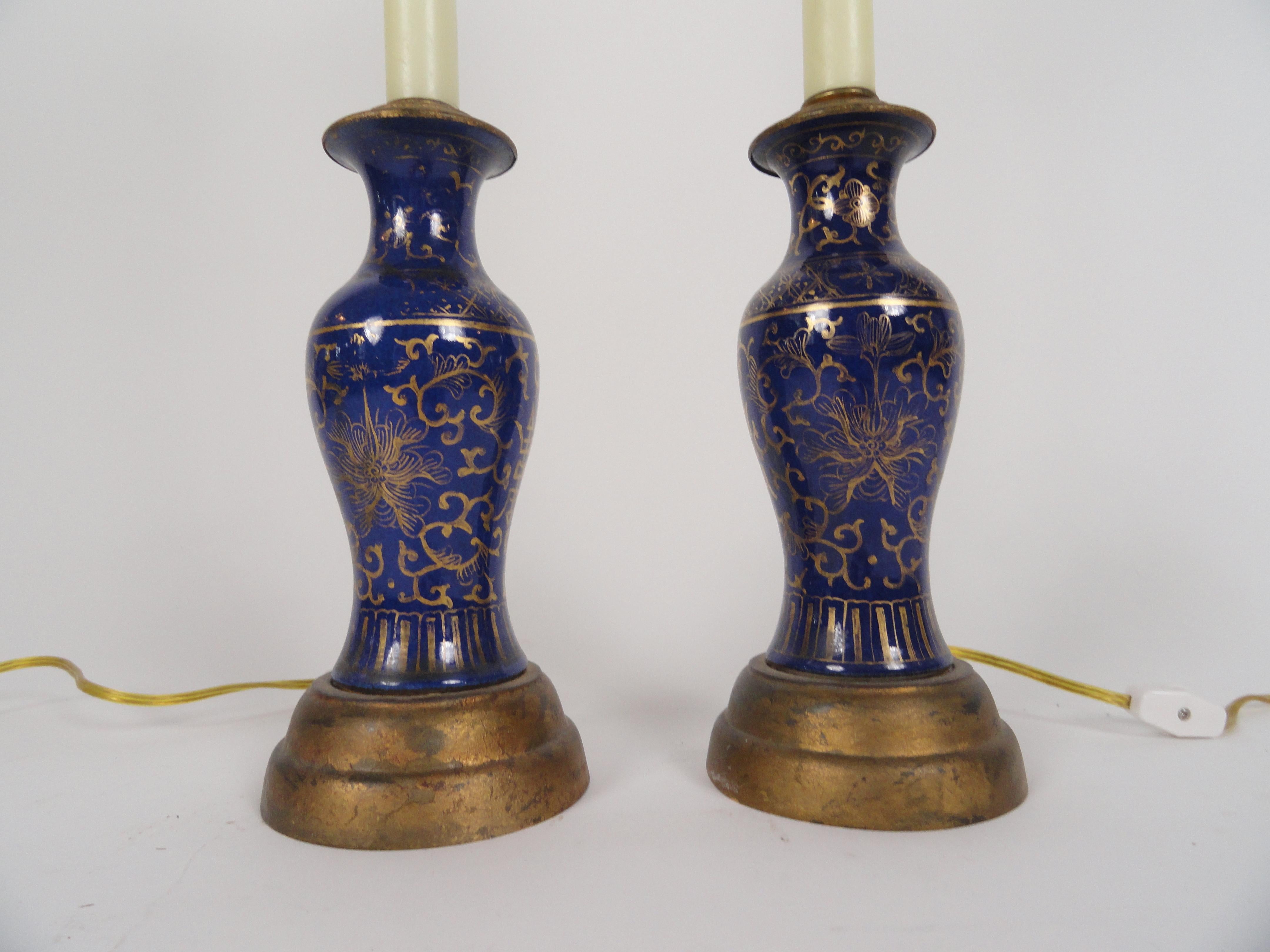 Pair of oriental powder blue candlestick lamps on gold bases. Fortuny half shades. Newly wired with inline switches.
Measures: 22