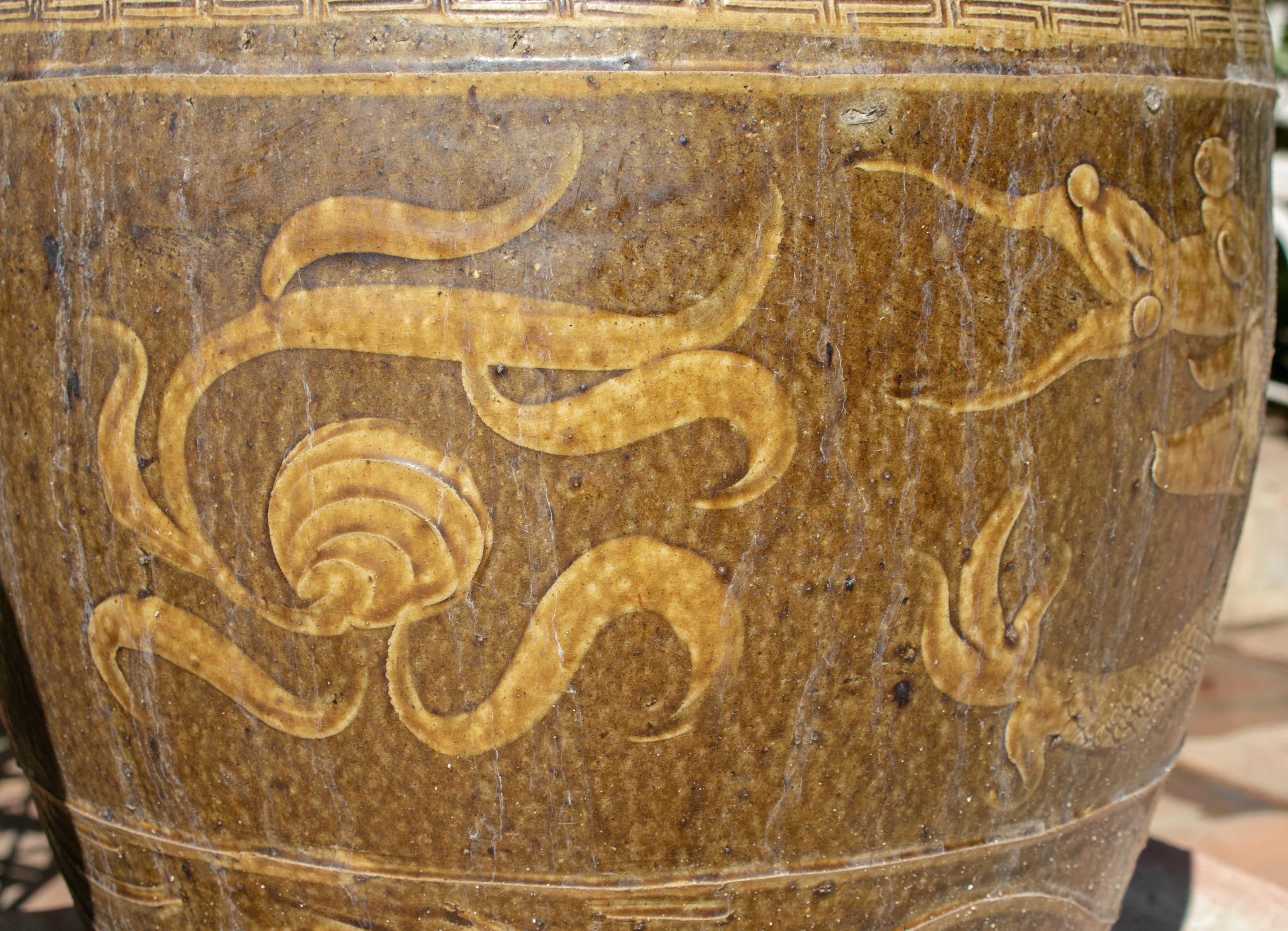 Glazed Pair of Oriental Style Ochre Colored Pots with Dragon Decoration