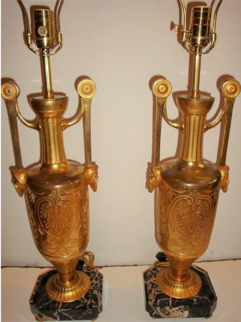 The Following Item we are offering is an Outstanding Pair of Rare Gilt Bronze Table Top Lamps, Exquisitely adorned with Finely Detailed Mounted Bronze Handles with Bearded Male Busts on each side. Bronze work is beautifully done with a repeated