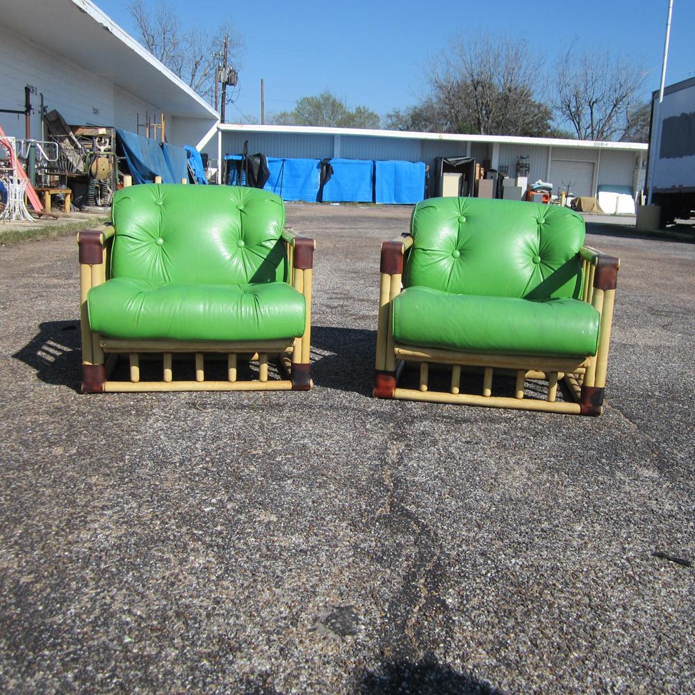 Two vintage original bamboo lounge chairs by Ficks Reed, circa 1970's. Leather straps support the cushions and bamboo frames. Bright apple green upholstery with tufted cushions. 

Measures: Width 32