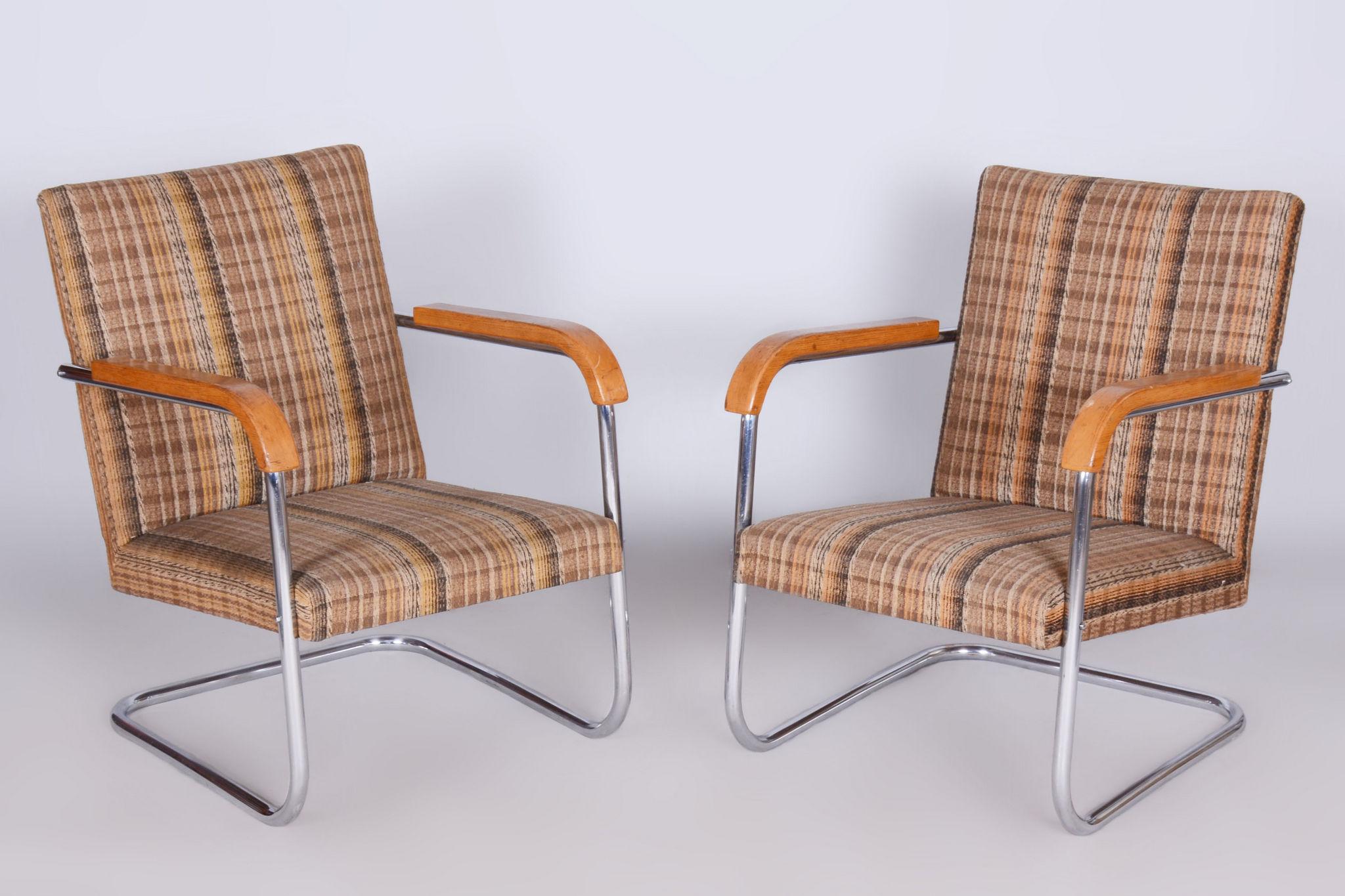 Pair of original armchairs from Czechoslovakia, 1930-1939.

In pristine original condition, the upholstery has been professionally cleaned, and its polish revived by our refurbishing team in Czechia. 							

This item features classic Bauhaus