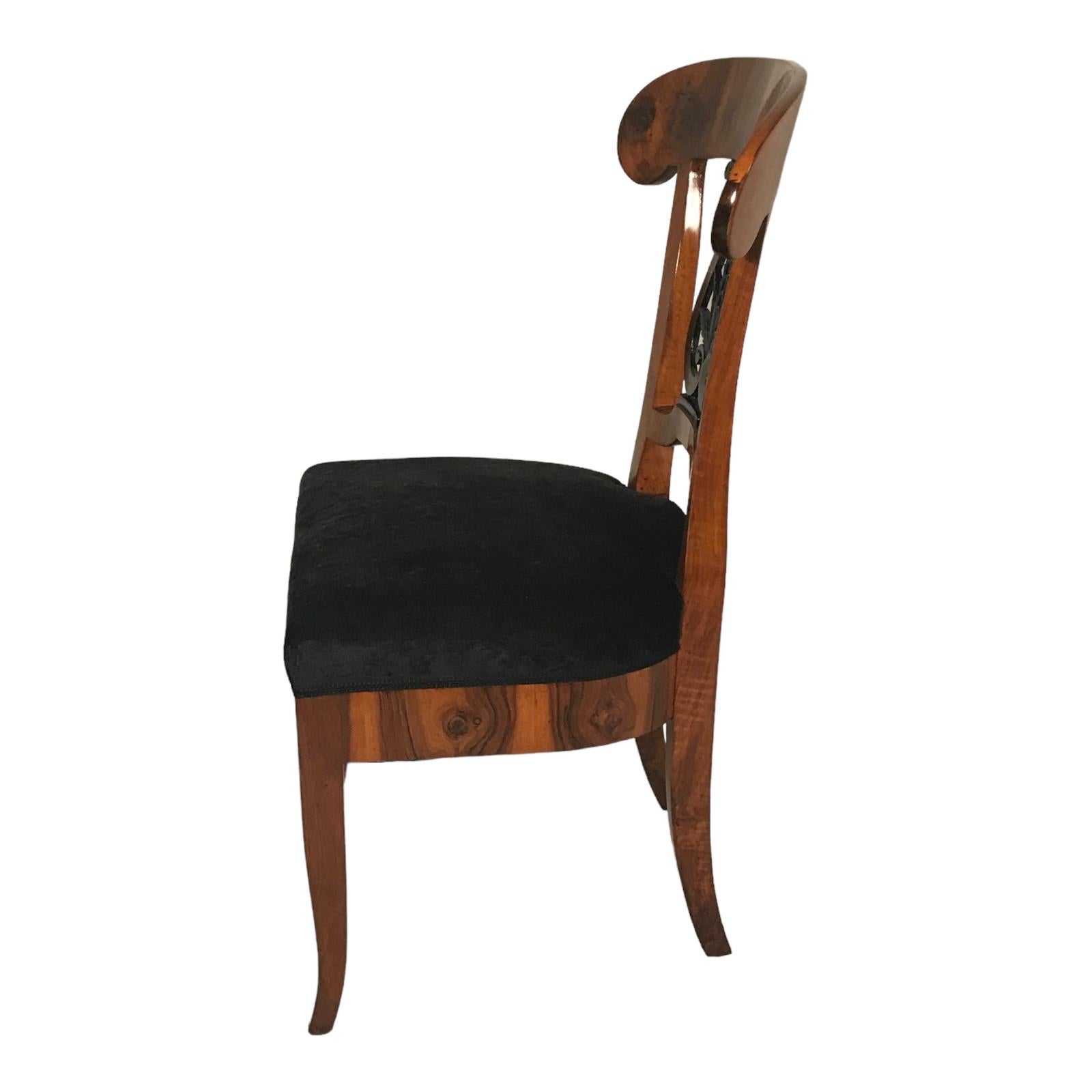 Explore our stunning pair of original Biedermeier chairs, originating from 1820s Southern Germany. Crafted with gorgeous walnut veneer, these chairs boast an exquisite back design accented with ebonized open work leaf decor. Meticulously refinished