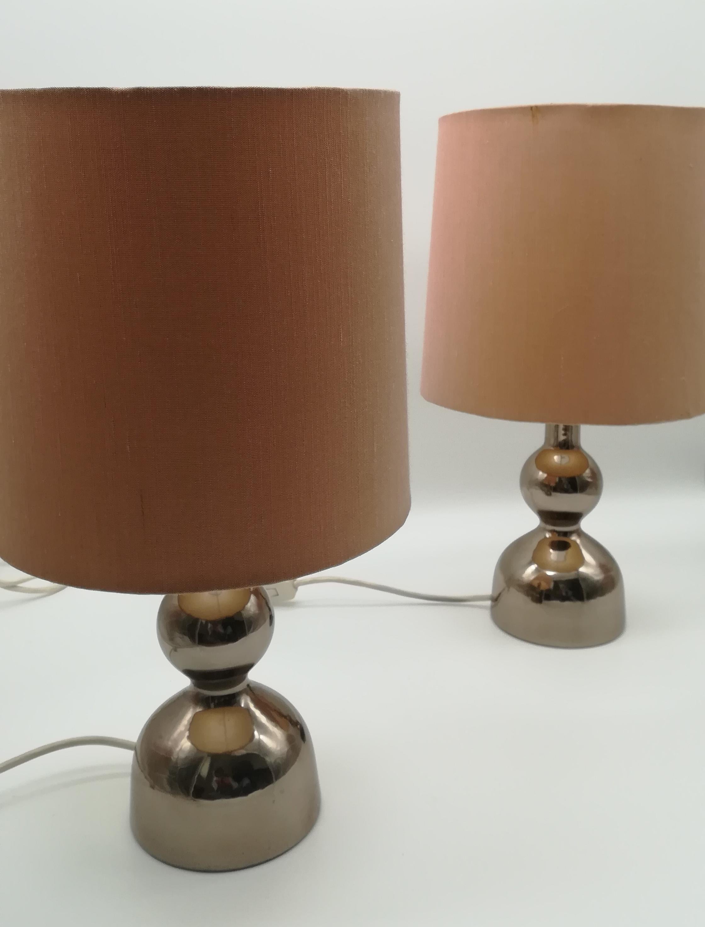 This lovely vintage pair of Mid-Century nightstand lamps from Austria, one of which still bears its label identifying the original Kalmar design, elegantly echoes Space Age style or else Stilnovo design.
Austrian designer Julius Theodor (J. T.)