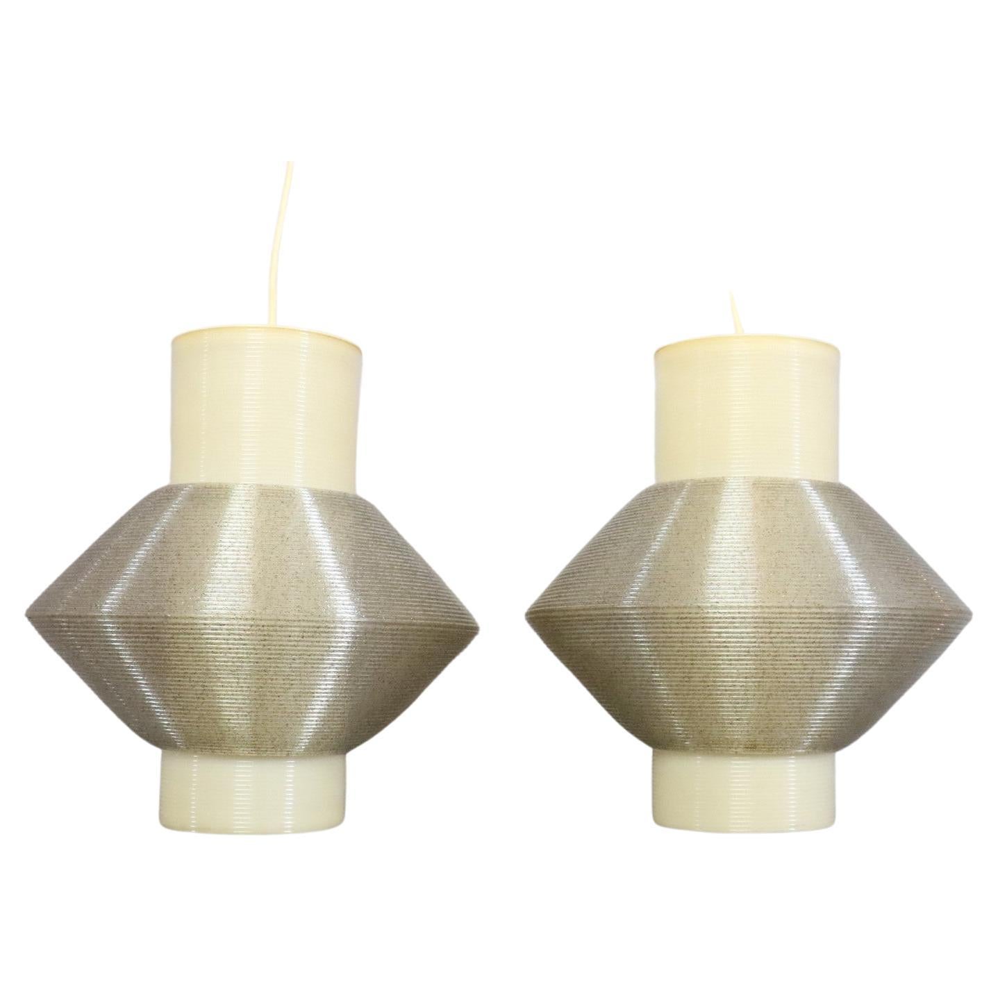 Pair of Original Large 1960s Heifetz Rotaflex Pendant Lamps

Pair of very decorative Rotaflex pendants lights. 
Two-tone, the creamy white is enhanced by a slightly glittery grey-beige part. Very well made, they produce a soft light.
Very good